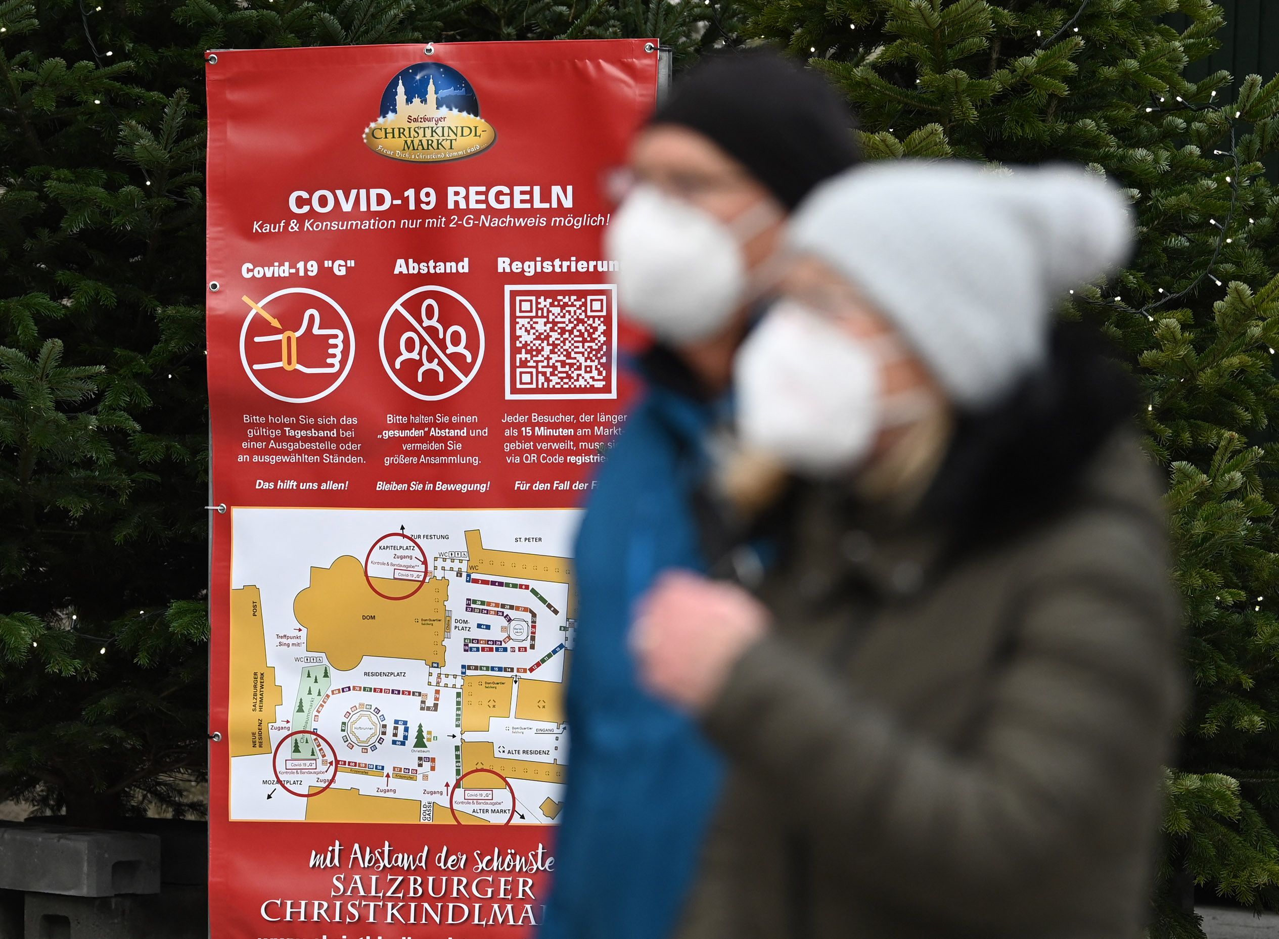 A sign displays rules for visitors of the christmas market amid the novel coronavirus COVID-19 pandemic in Salzburg, on November 19, 2021