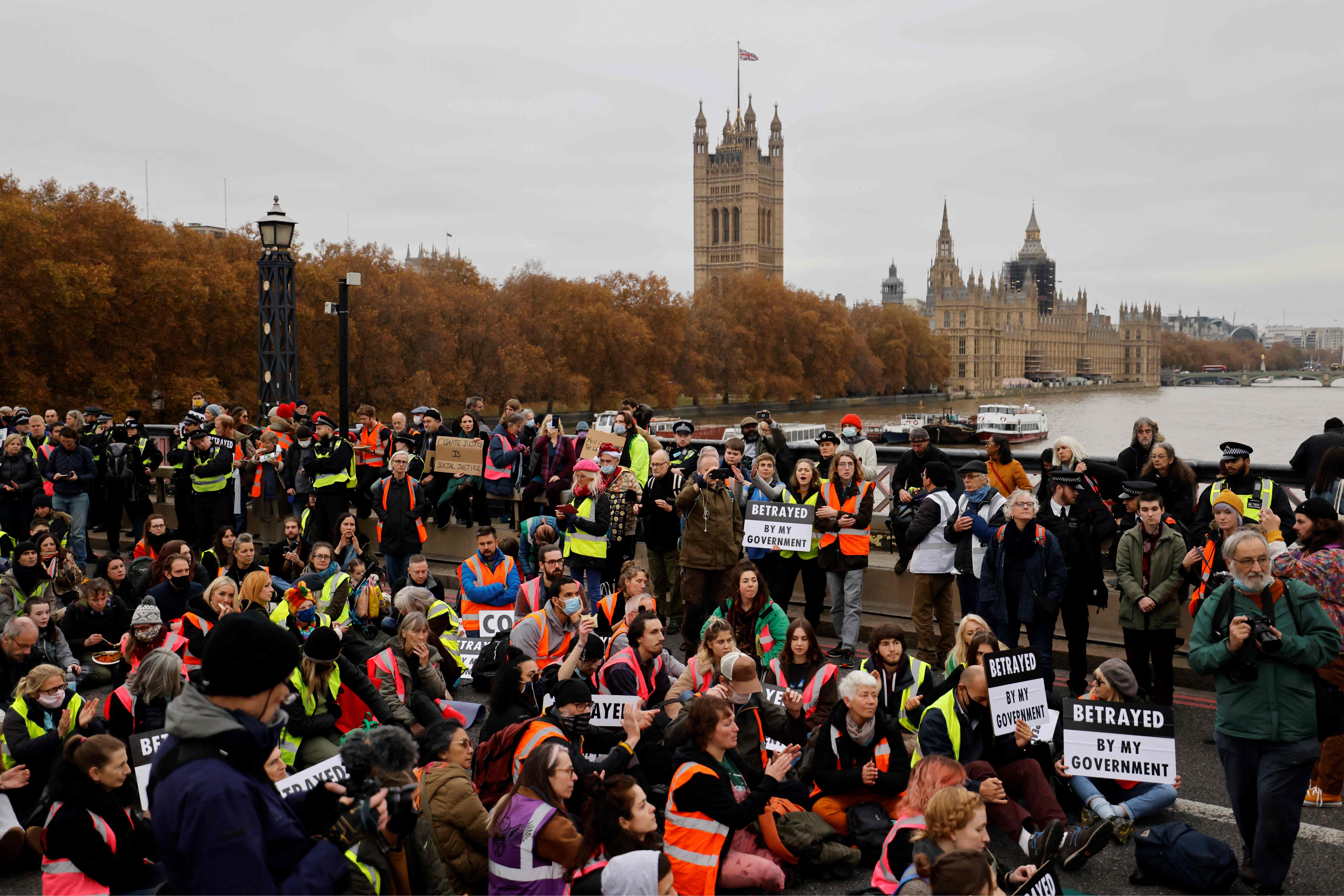 Climate change activists block traffic during a protest action in solidarity with activists from the Insulate Britain group, who received prison terms for blocking roads