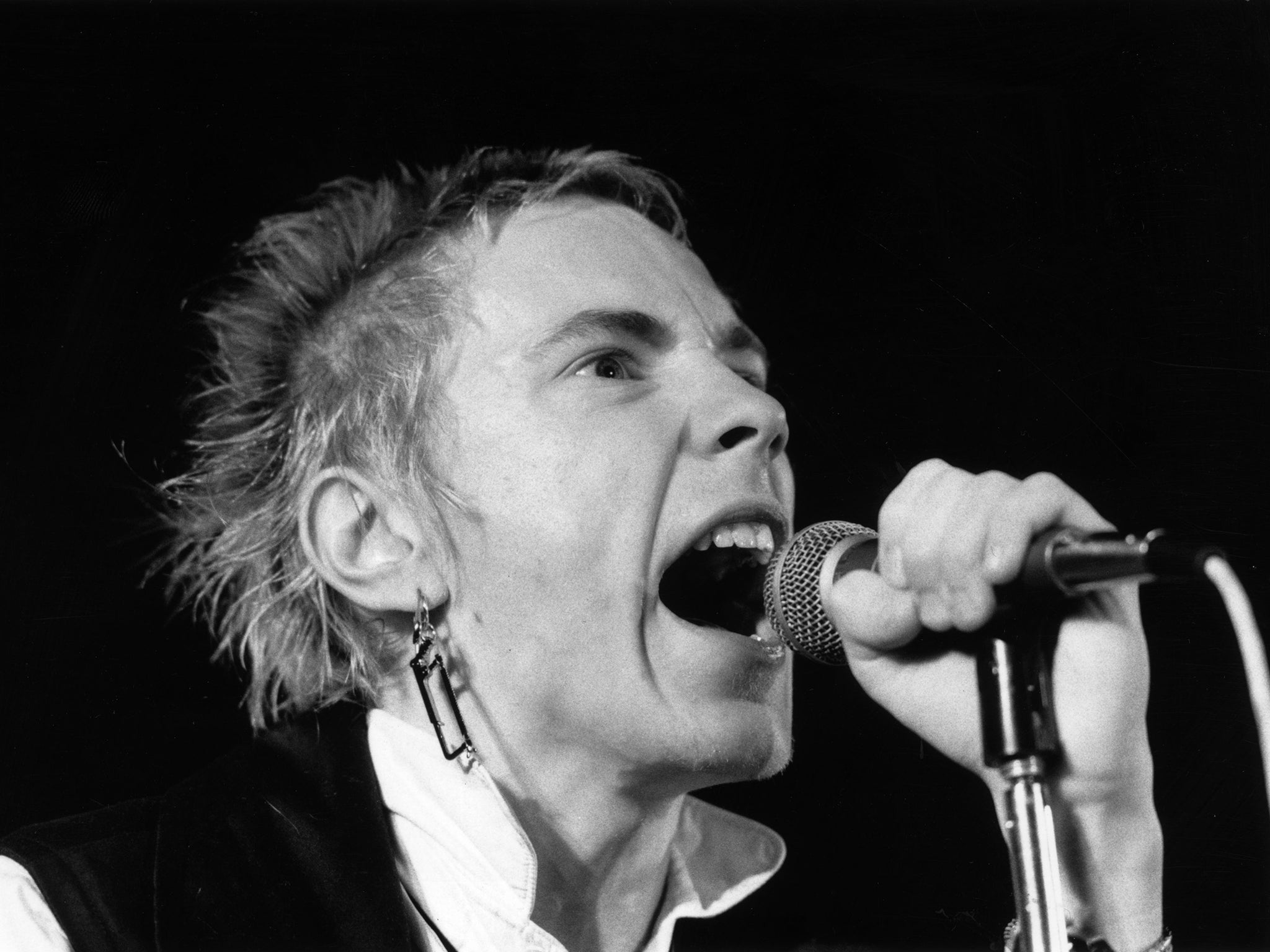 Johnny Rotten performs on stage in December 1976