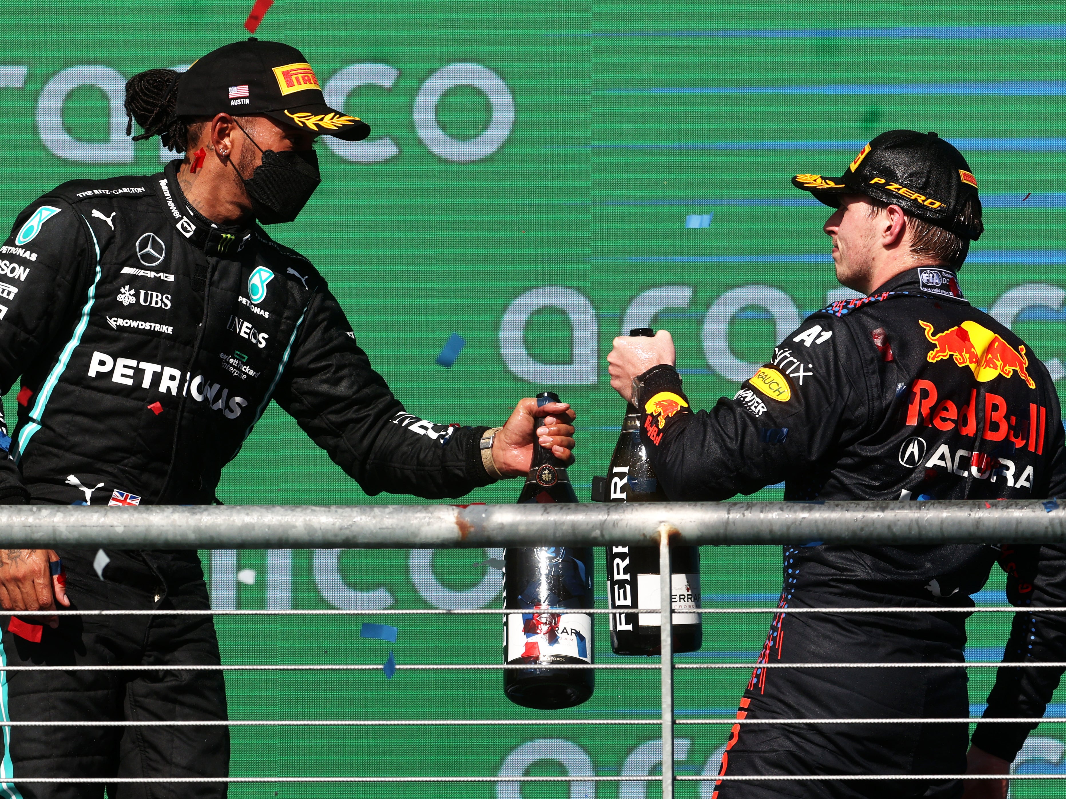 Max Verstappen (right) holds a slender lead over Lewis Hamilton with two races remaining