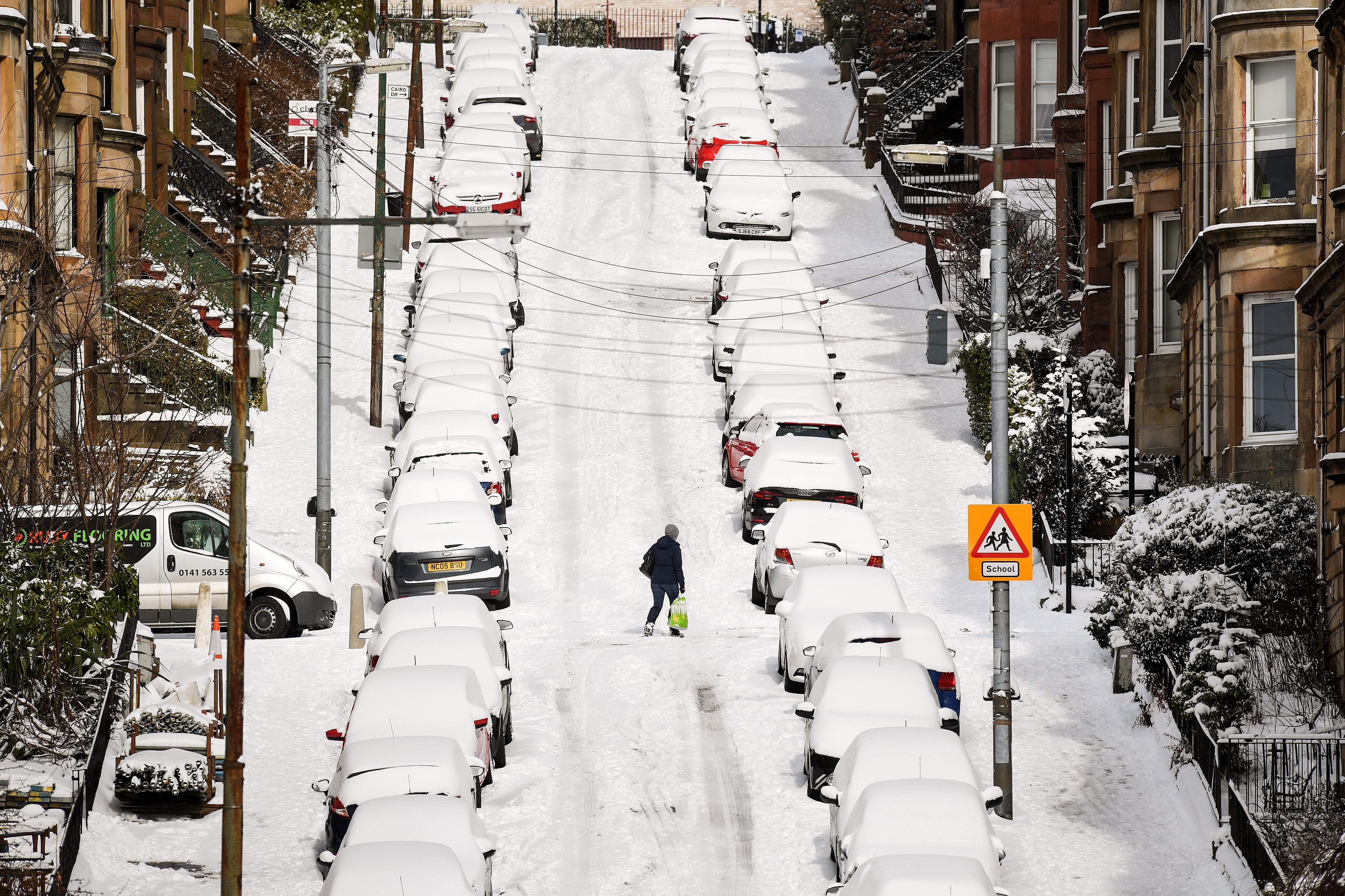 Members of the public make their way through the snow in Glasgow, 2018