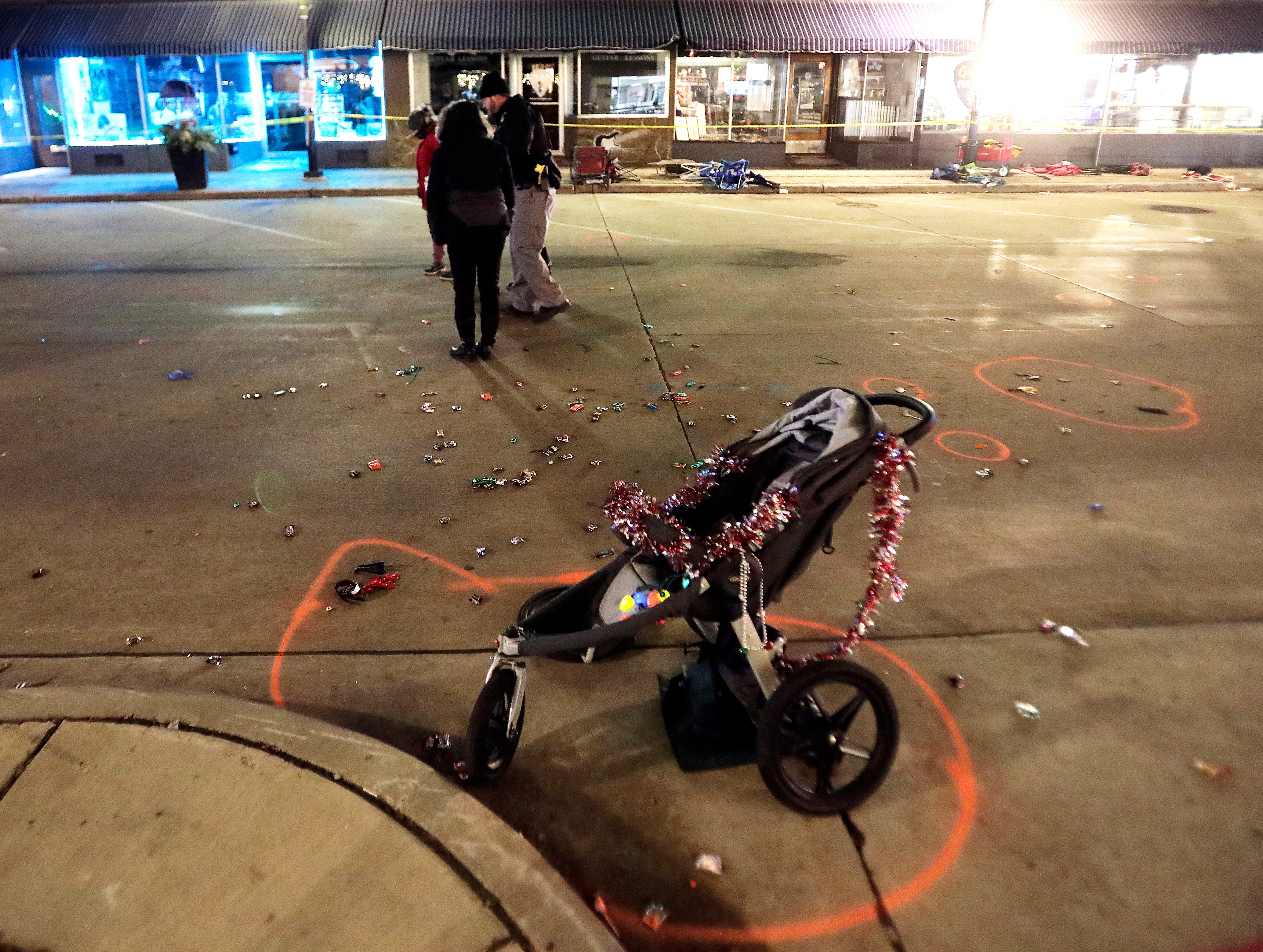 A broken children’s stroller lies on W Main St in downtown Waukesha, Wisconsin, after an SUV drove into a parade of Christmas marchers