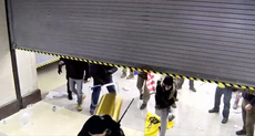 Newly released video shows pro-Trump Capitol rioters using chairs and garbage cans to stop police closing an automatic door