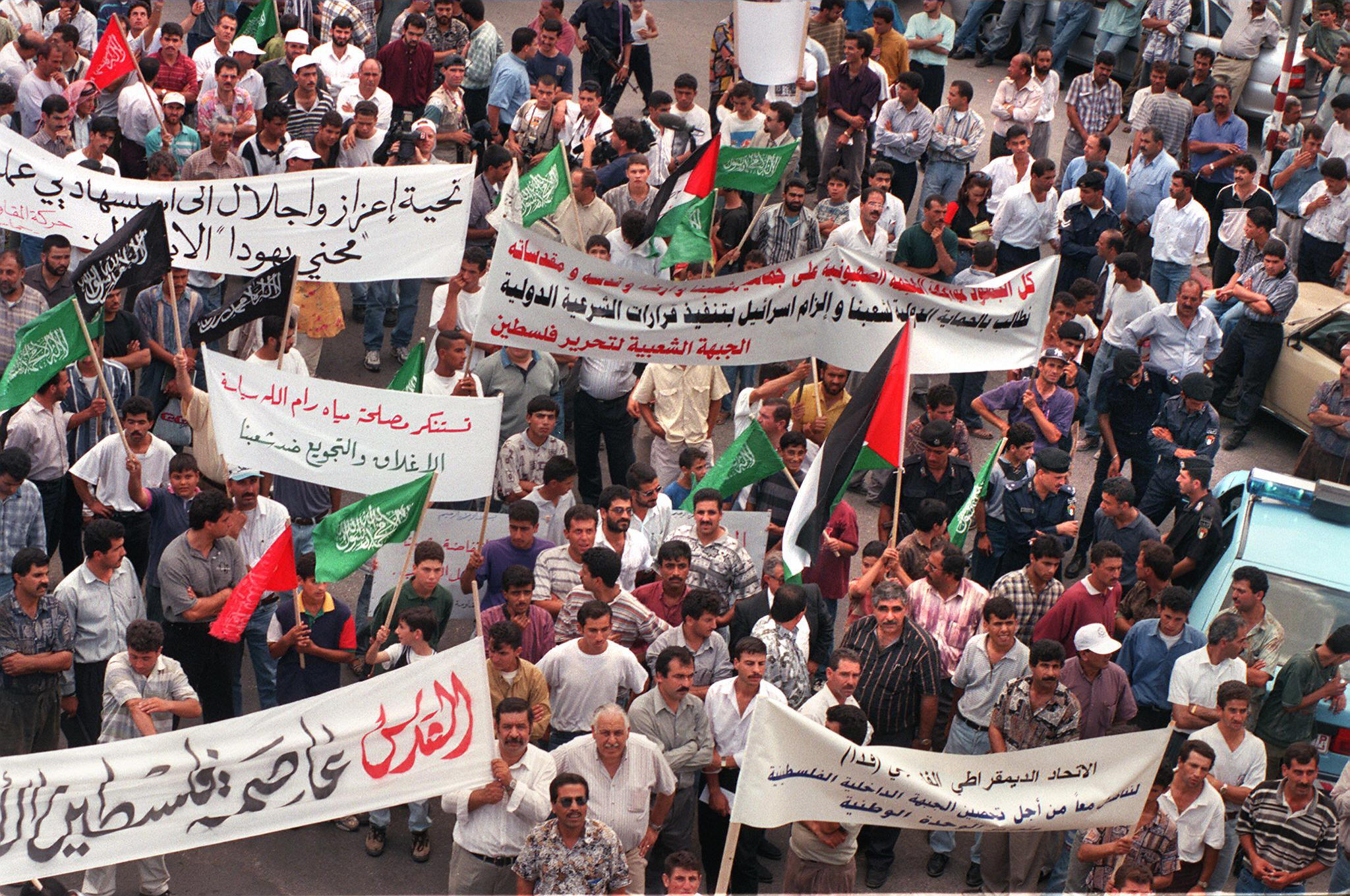 Palestinian demonstrators march through Ramallah in protest against an Israeli blockade of Palestinian areas imposed following the double suicide bombing in Jerusalem in July 1997