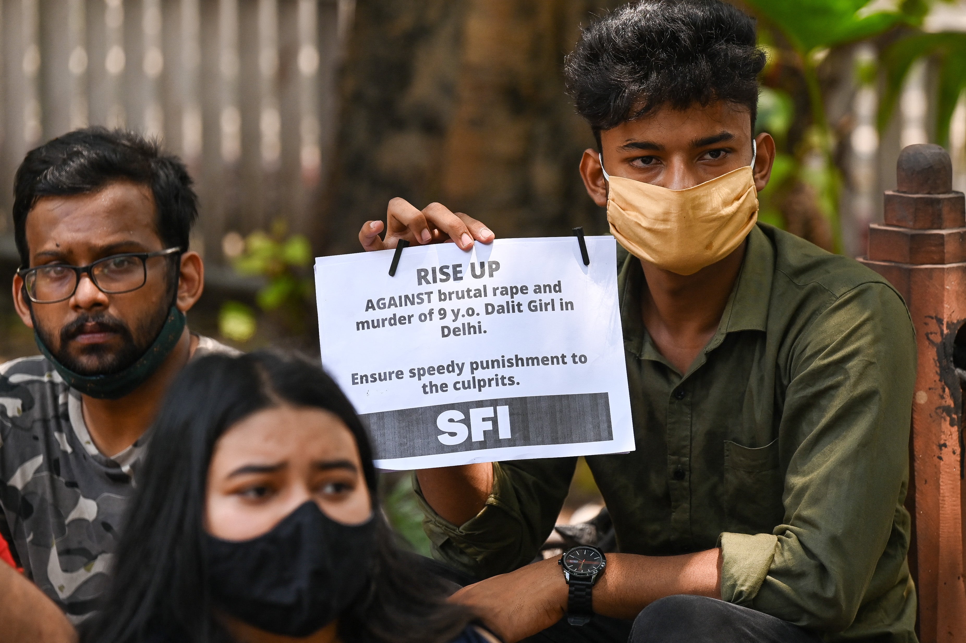 Activists hold placards to protest the alleged rape and murder of a nine-year-old girl in New Delhi on 4 August. In 2020, India registered at least 43,000 cases under the Pocso Act