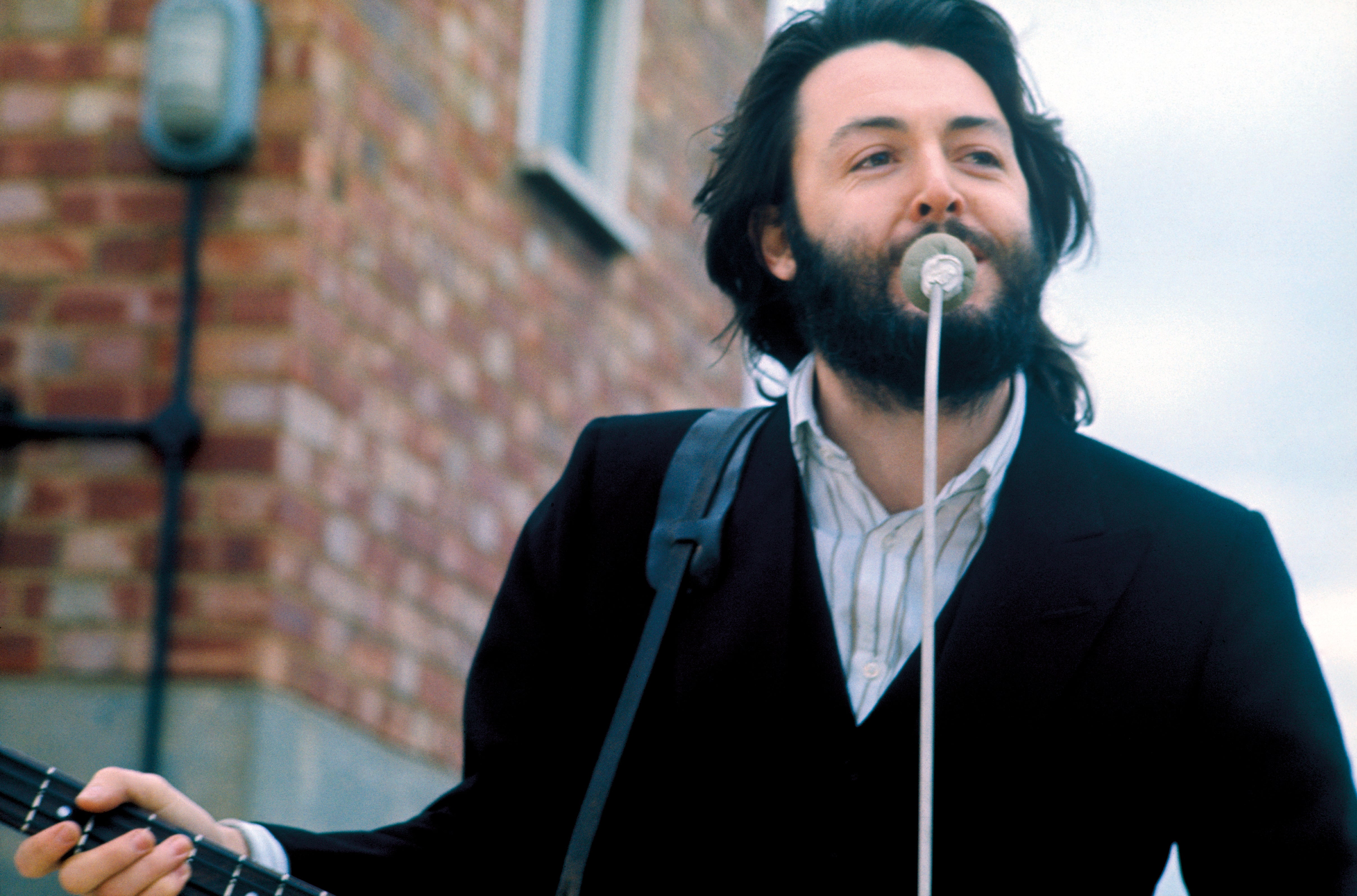 Paul McCartney performing on the roof of Apple Corps , 1969