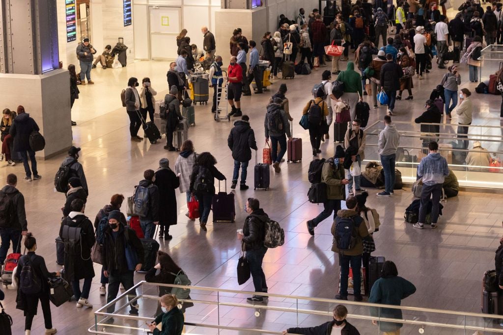 Passengers wait for trains at Moynihan Station in New York on 24 November