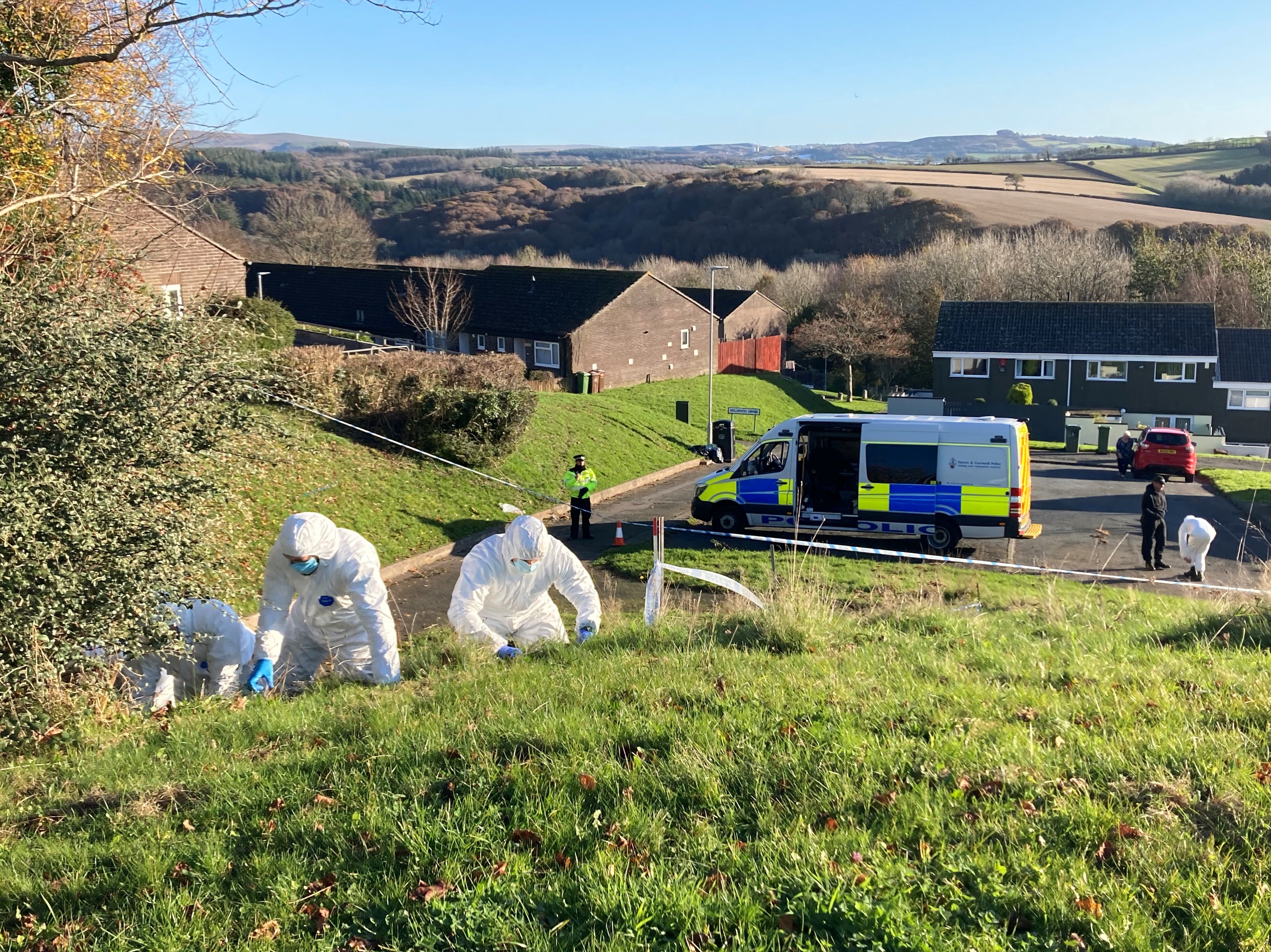 Police officers in white forensic suits comb for clues near a bus stop where 18-year-old Bobbi-Anne McLeod disappeared in Leigham, Plymouth