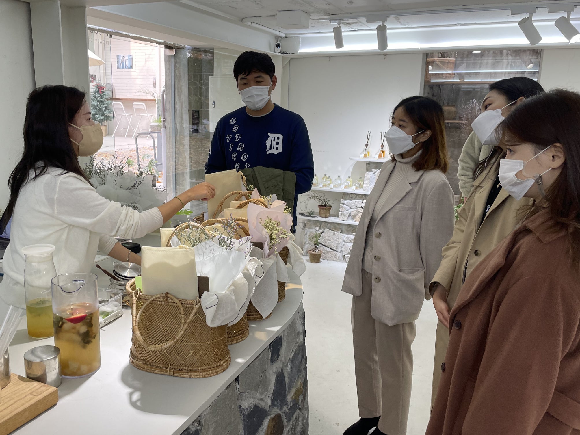 Customers receive their teas and baskets of flowers and stationery in order to take a break from daily life at Green Lab cafe, South Korea