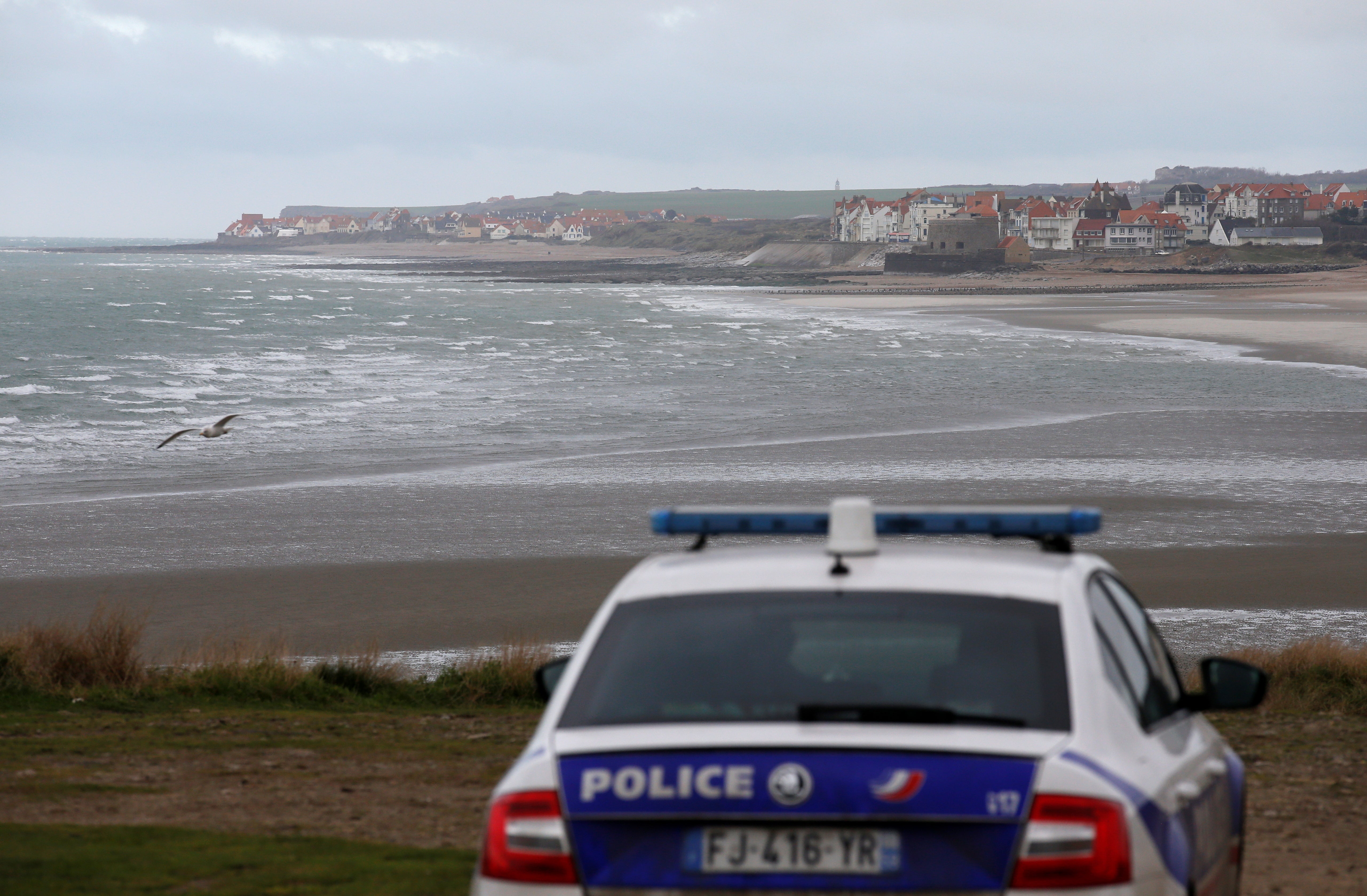 French police patrol Wimereux, near Calais, the day after 27 migrants died attempting to cross the Channel