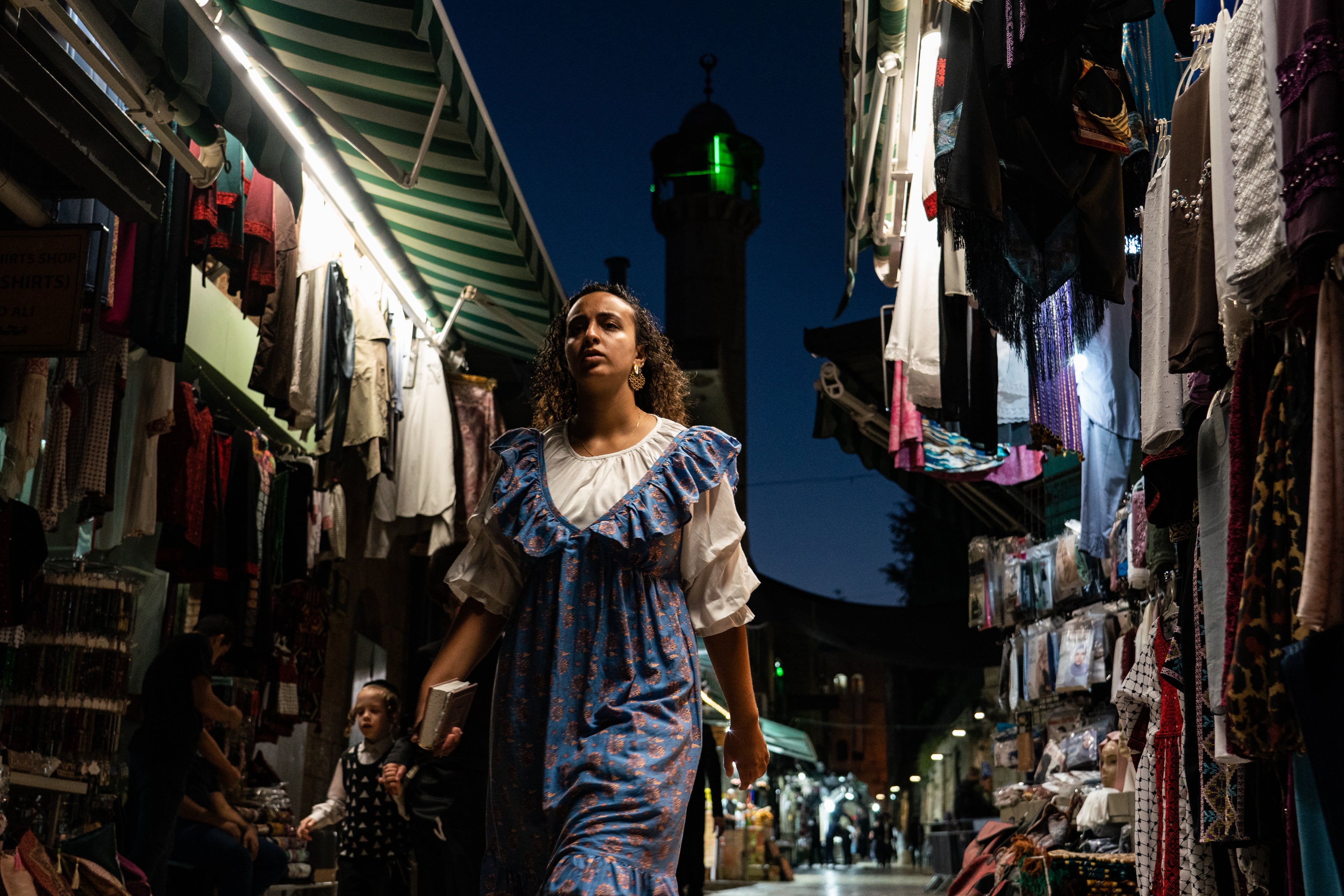 Jews on their way to the Western Wall pass Muslim-owned shops in Jerusalem