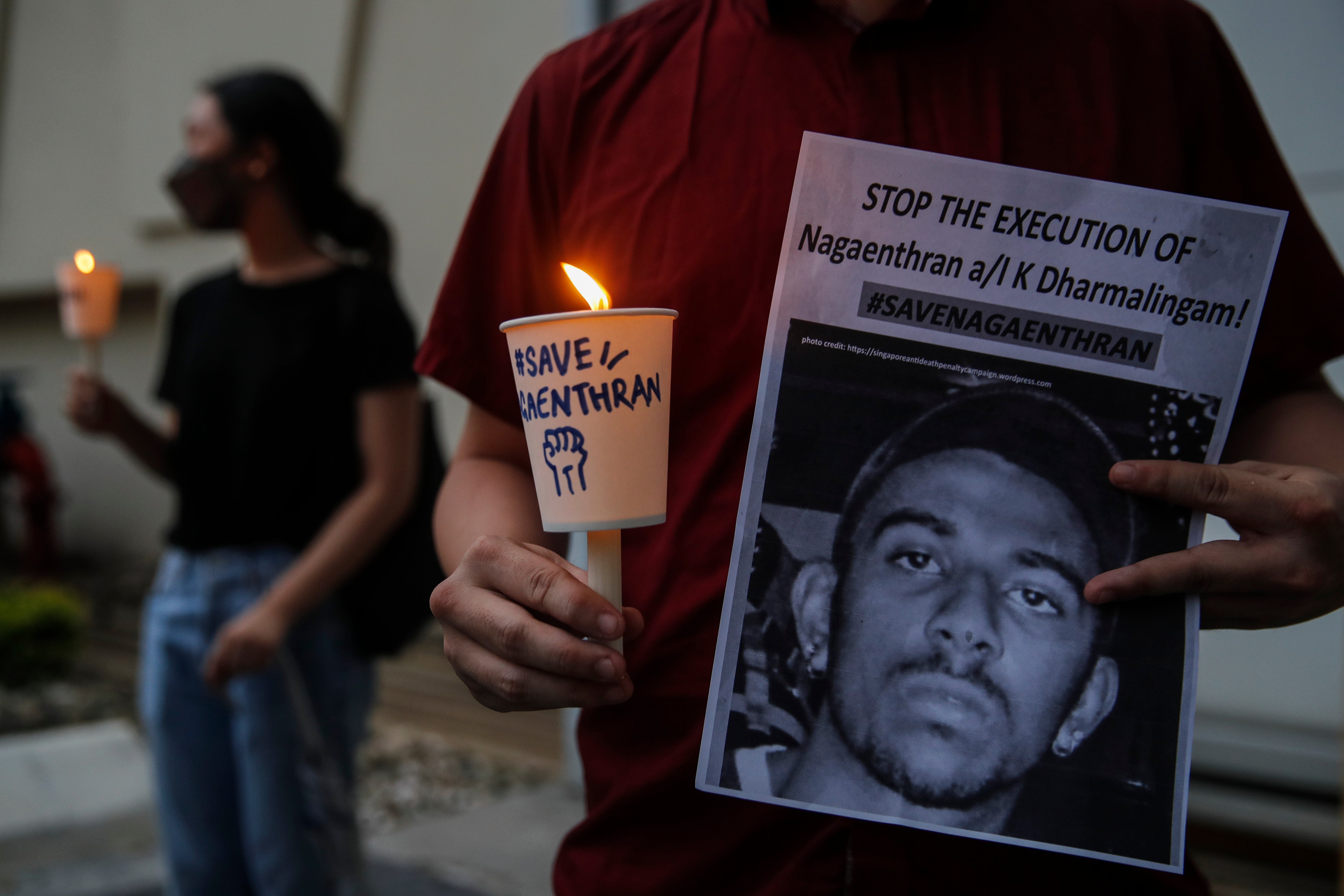 An activist holding a placard at a recent vigil for Dharmalingam in Malaysia’s capital