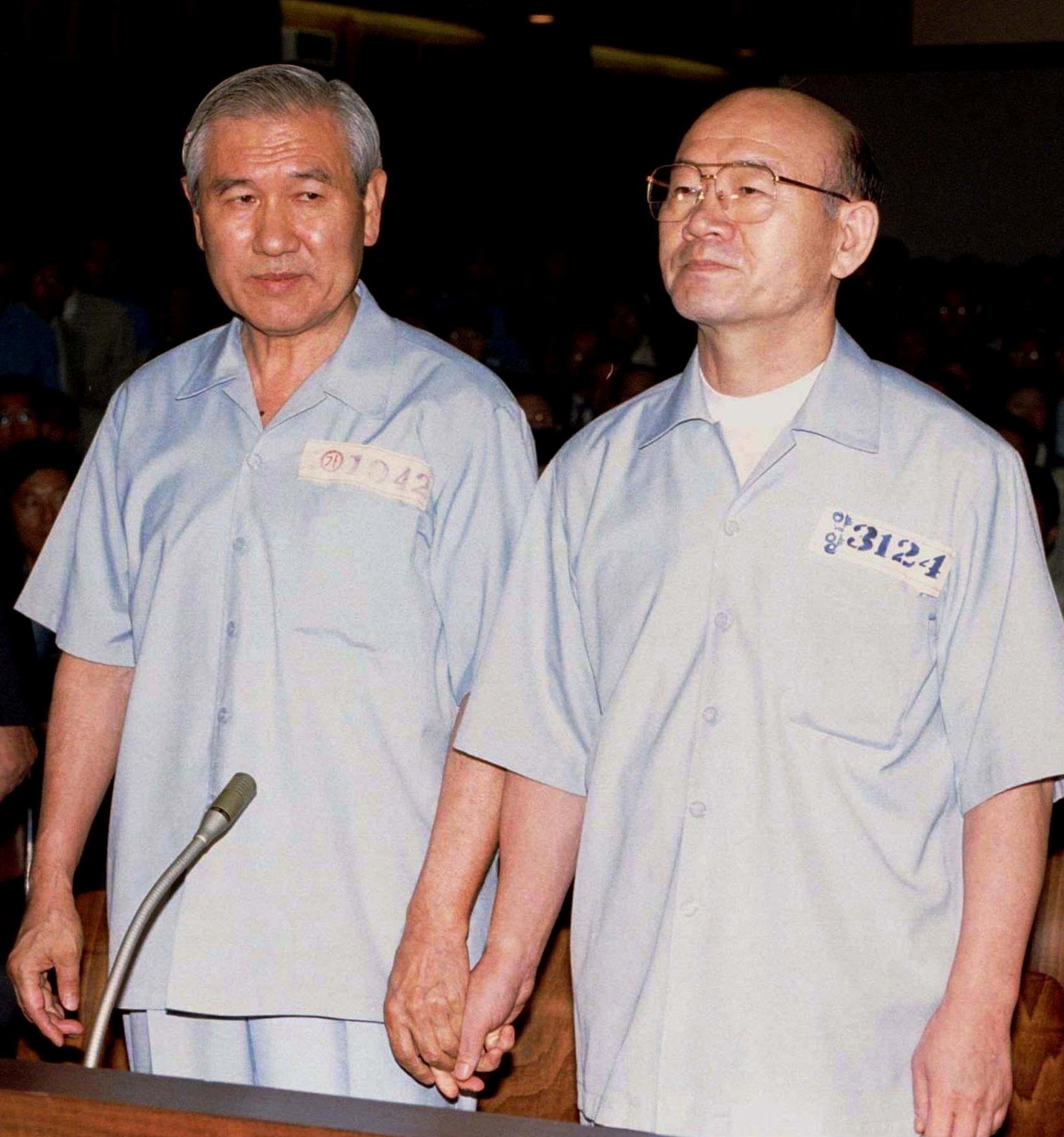 File photo taken on 26 August 1996 shows former South Korean president Chun Doo-hwan and his successor Roh Tae-woo (L) who were sentenced life in jail for mutiny, treason and bribery