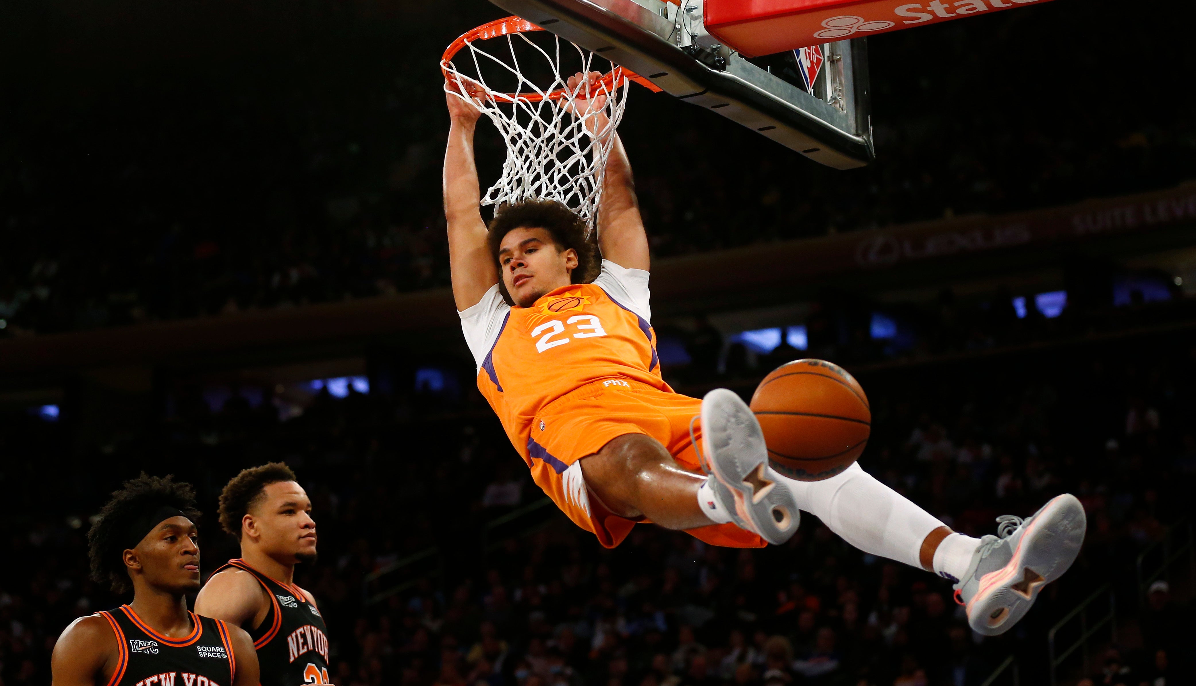 Cam Johnson dunks for Phoenix (John Munson/AP)