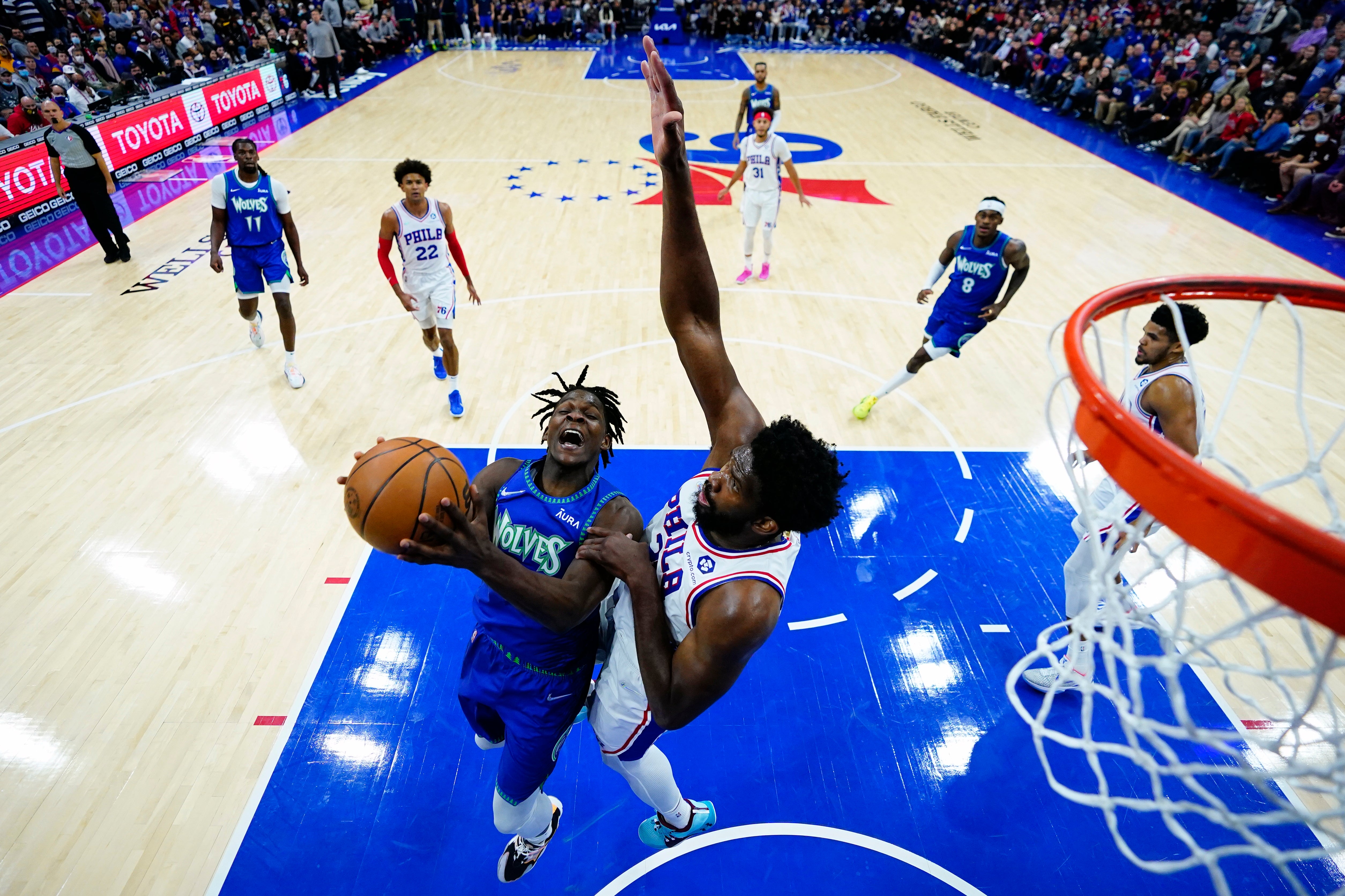 Minnesota Timberwolves’ Anthony Edwards, left, tries to get a shot past Philadelphia 76ers’ Joel Embiid (Matt Slocum/AP)