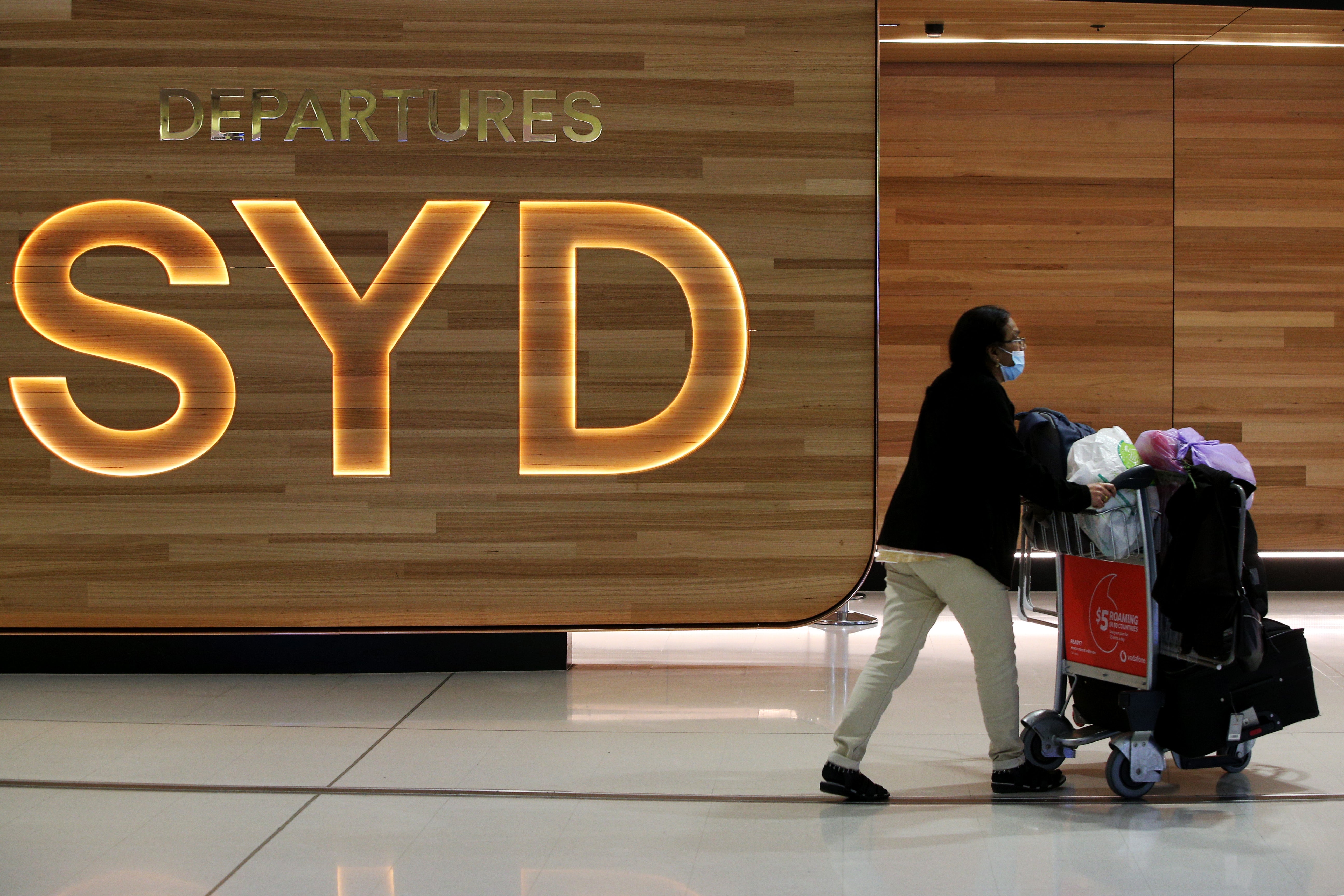 File: A passenger makes their way towards the departure lounge following check-in at Sydney's International Airport on 1 November 2021