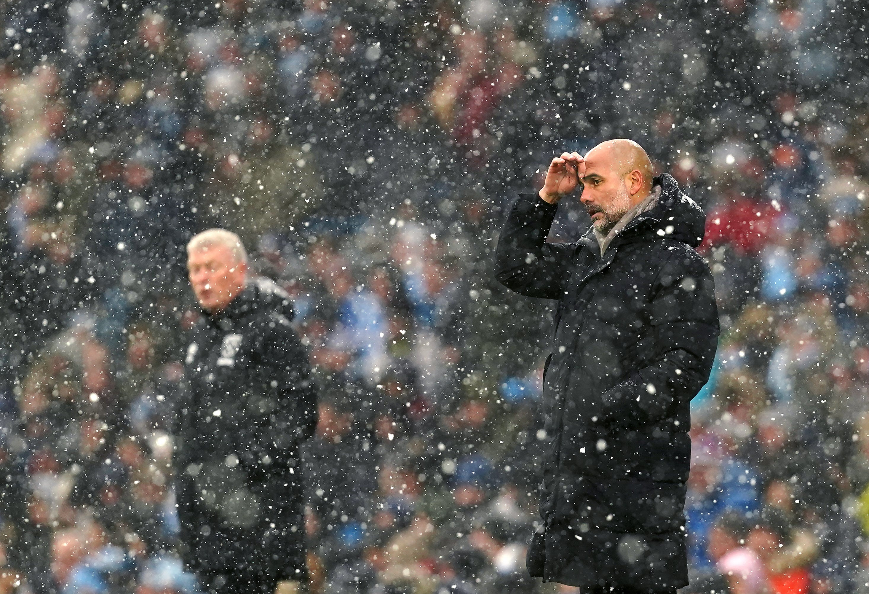 Pep Guardiola (right) got the better of David Moyes in snowy Manchester (Martin Rickett/PA)