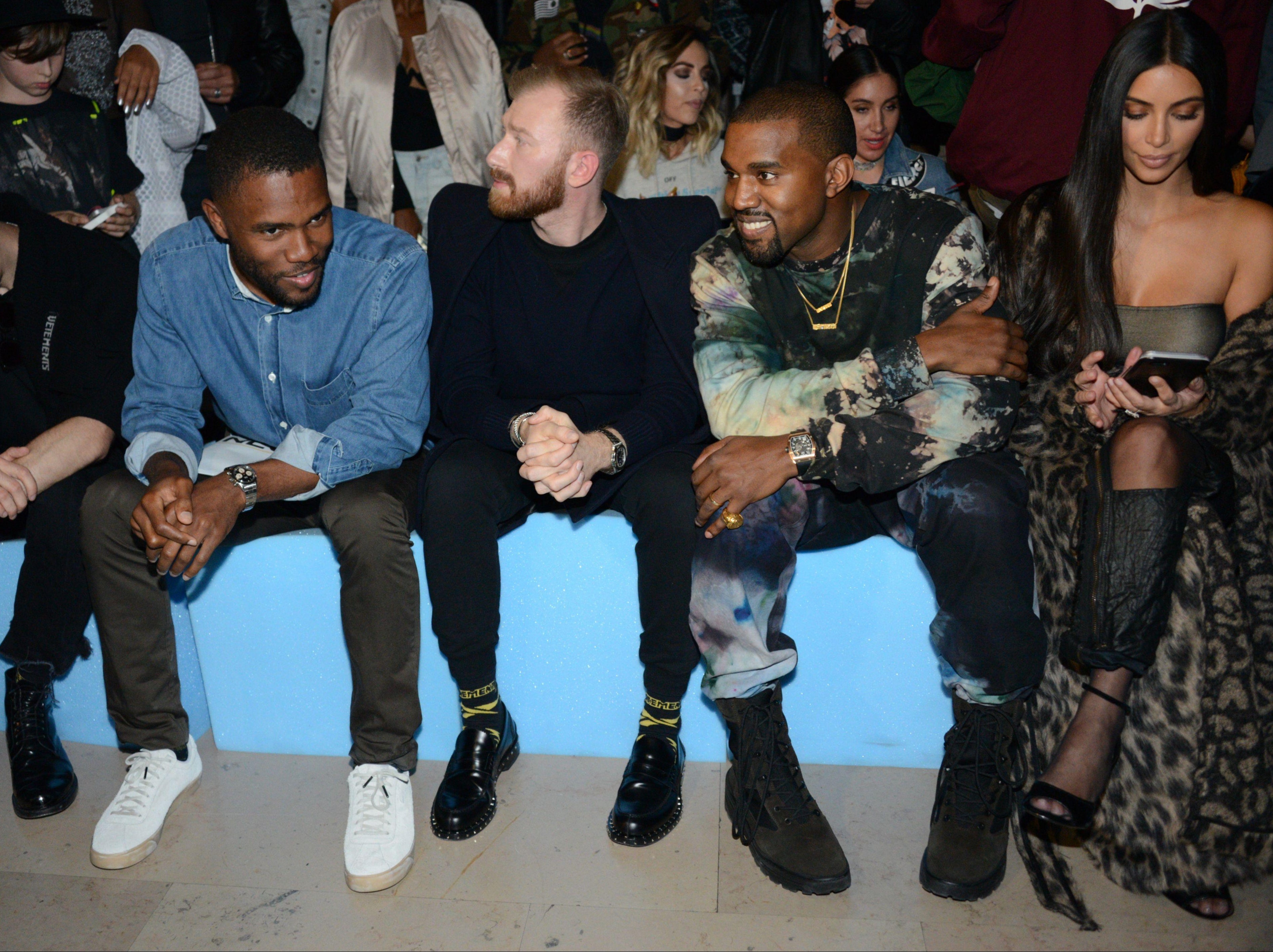 Frank Ocean (left, blue jacket) in the front row with Kanye West and Kim Kardashian at a 2016 Off-White show, Paris Fashion Week