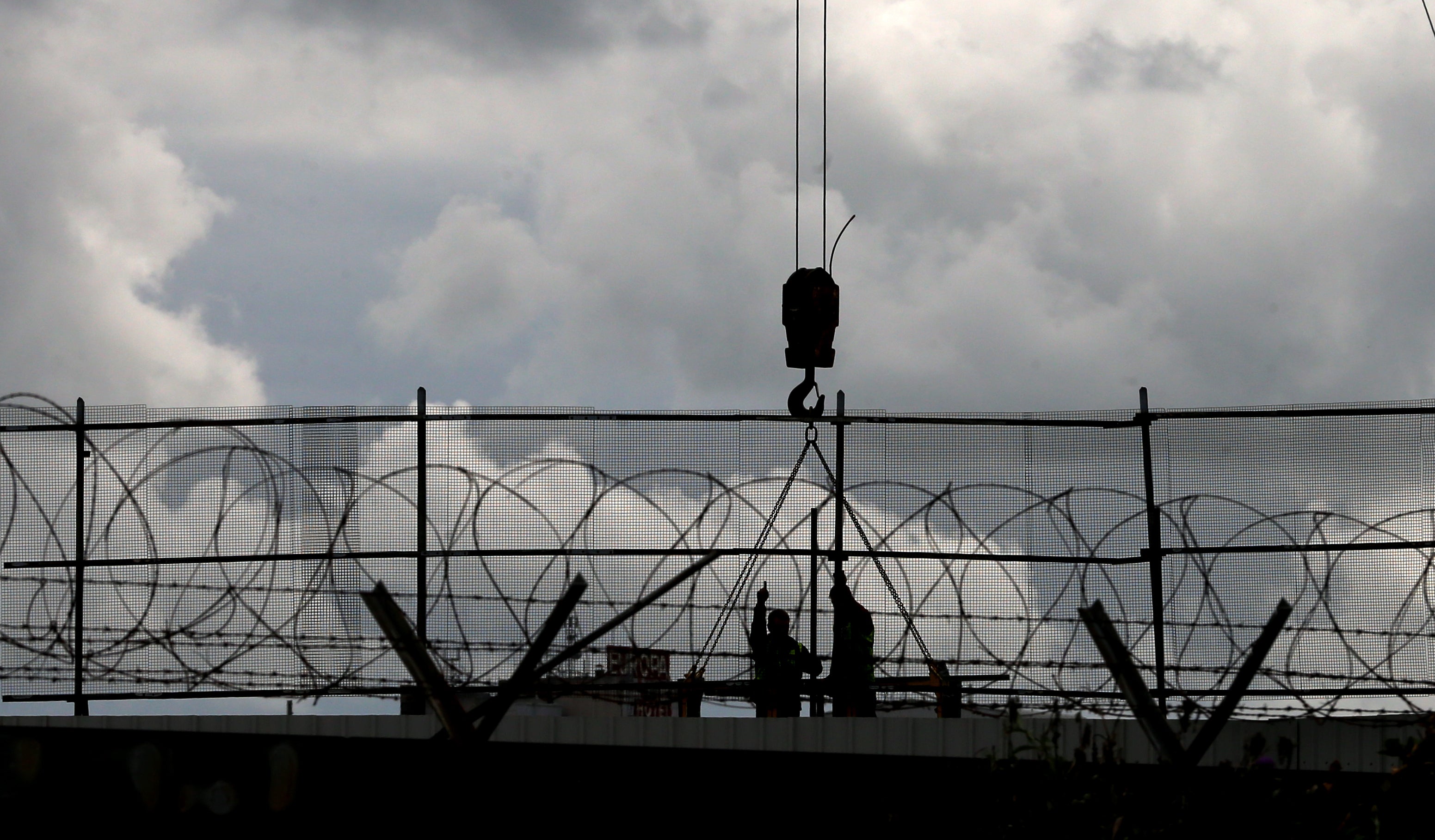 General repairs are carried out on one of Belfast oldest peace walls (Niall Carson/PA)