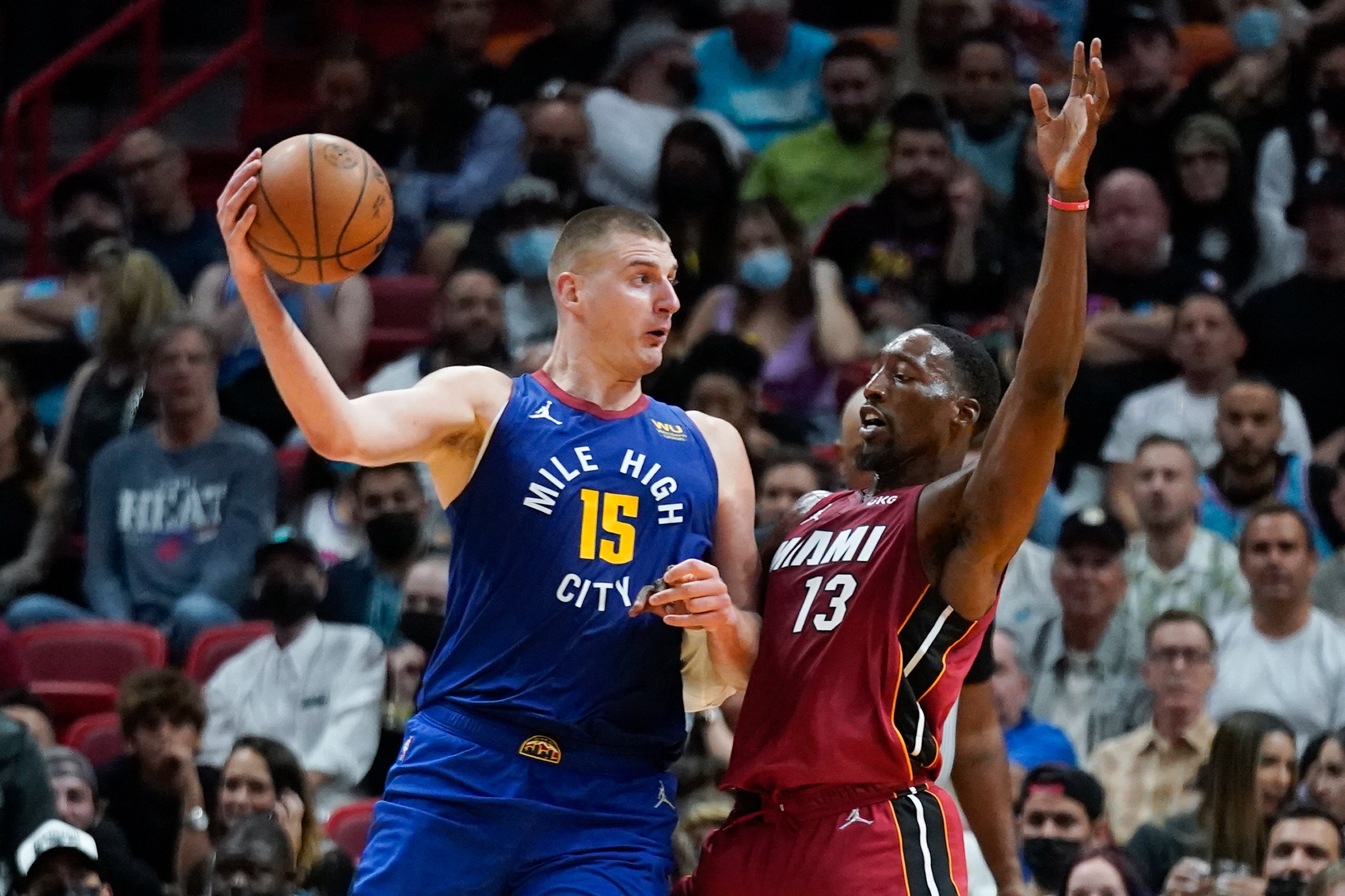 Denver Nuggets centre Nikola Jokic (15) passes past Miami Heat centre Bam Adebayo (13) (AP Photo/Wilfredo Lee)