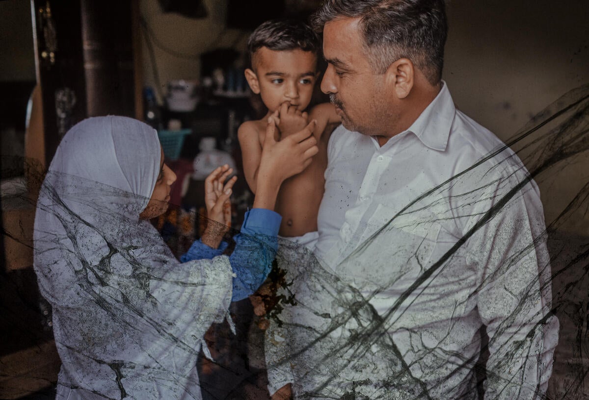 Zahra, 12, at home with her father and younger brother in Lahore