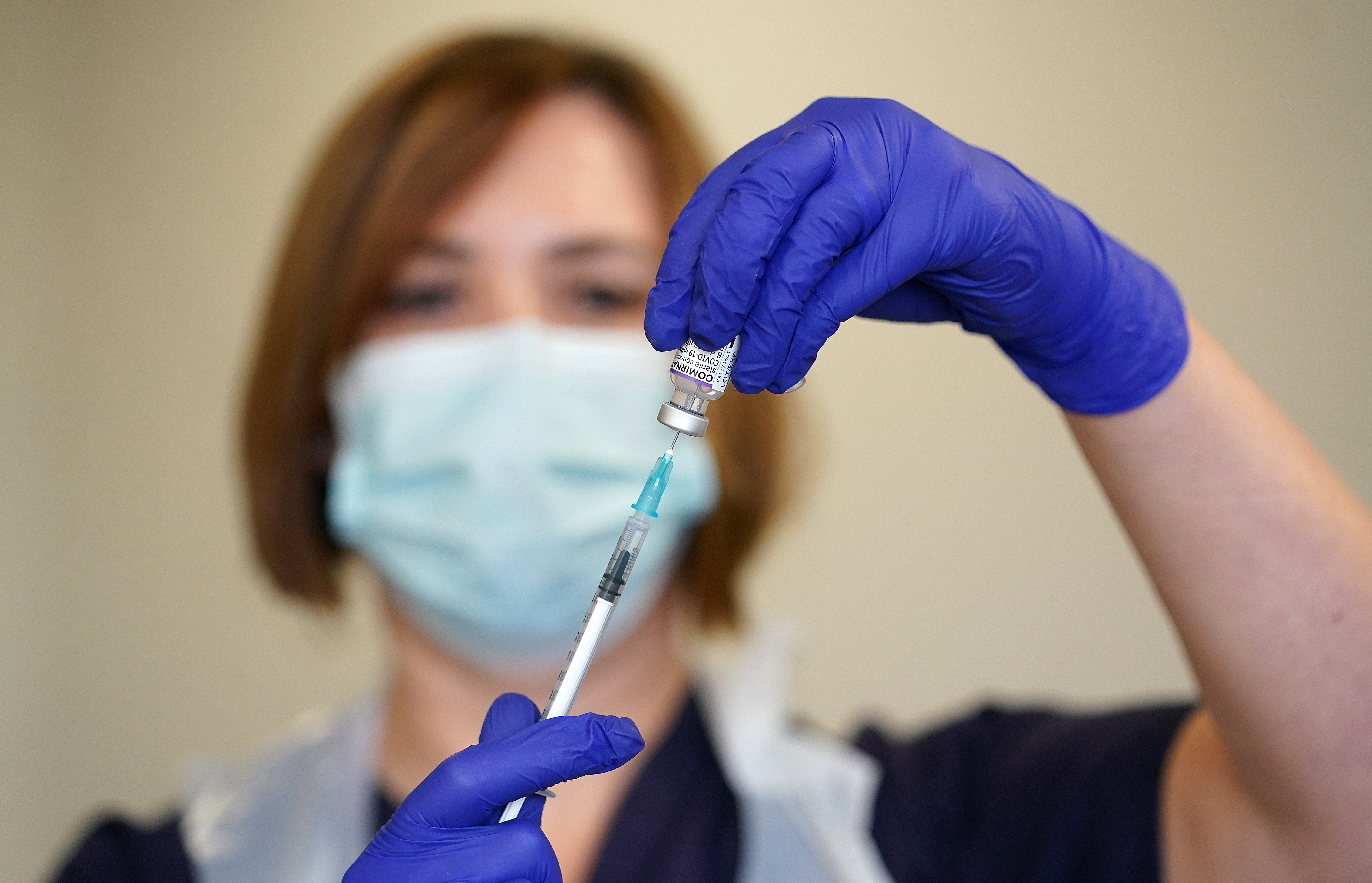 Nurse Heather Esmer draws a syringe before administering a Covid-19 vaccine booster at Birkenhead Medical Building in Merseyside (Martin Rickett/PA)