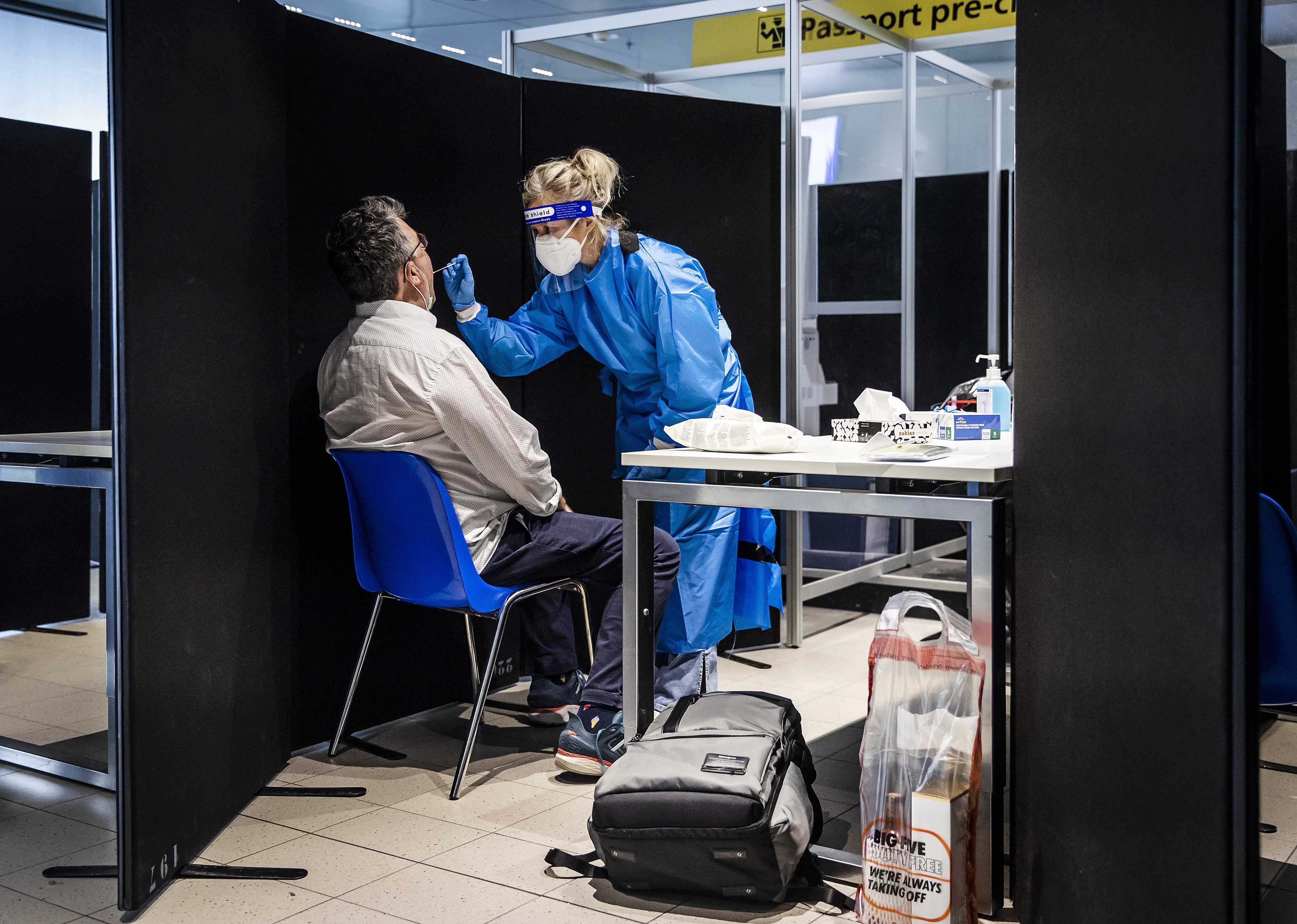 Travellers from South Africa are tested for the omicron variant upon arrival in a specially designed test lane at Schiphol airport