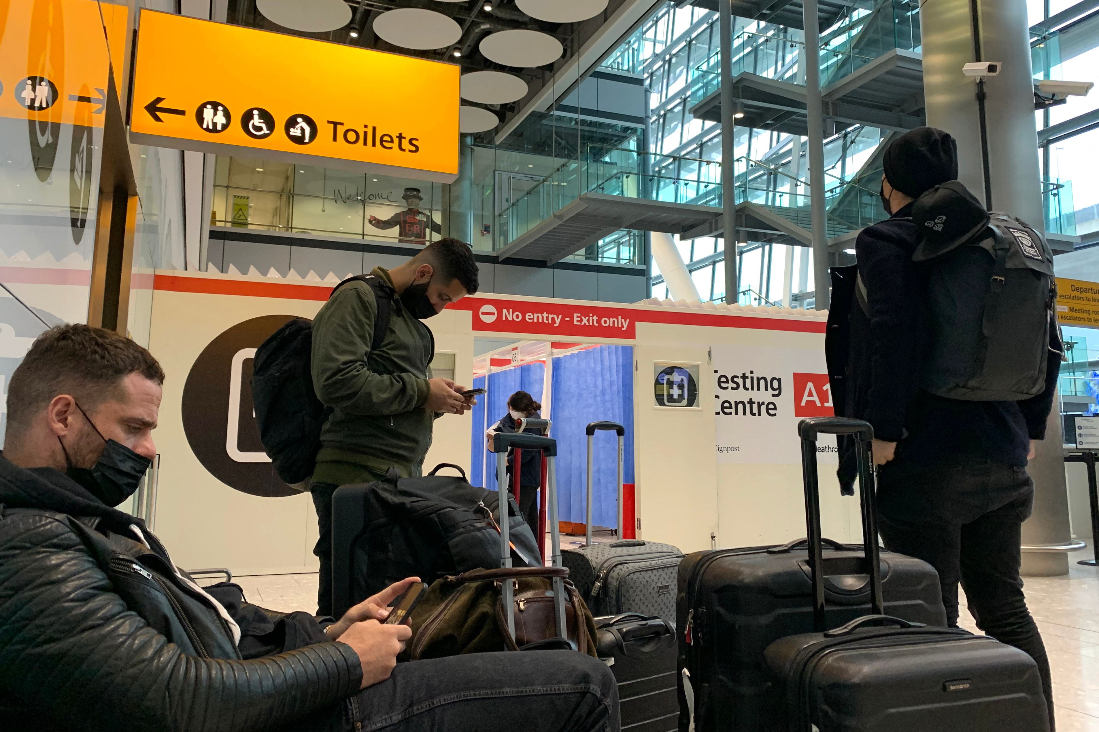 People wait outside the Covid-19 testing facility at Heathrow’s Terminal 5 in west London