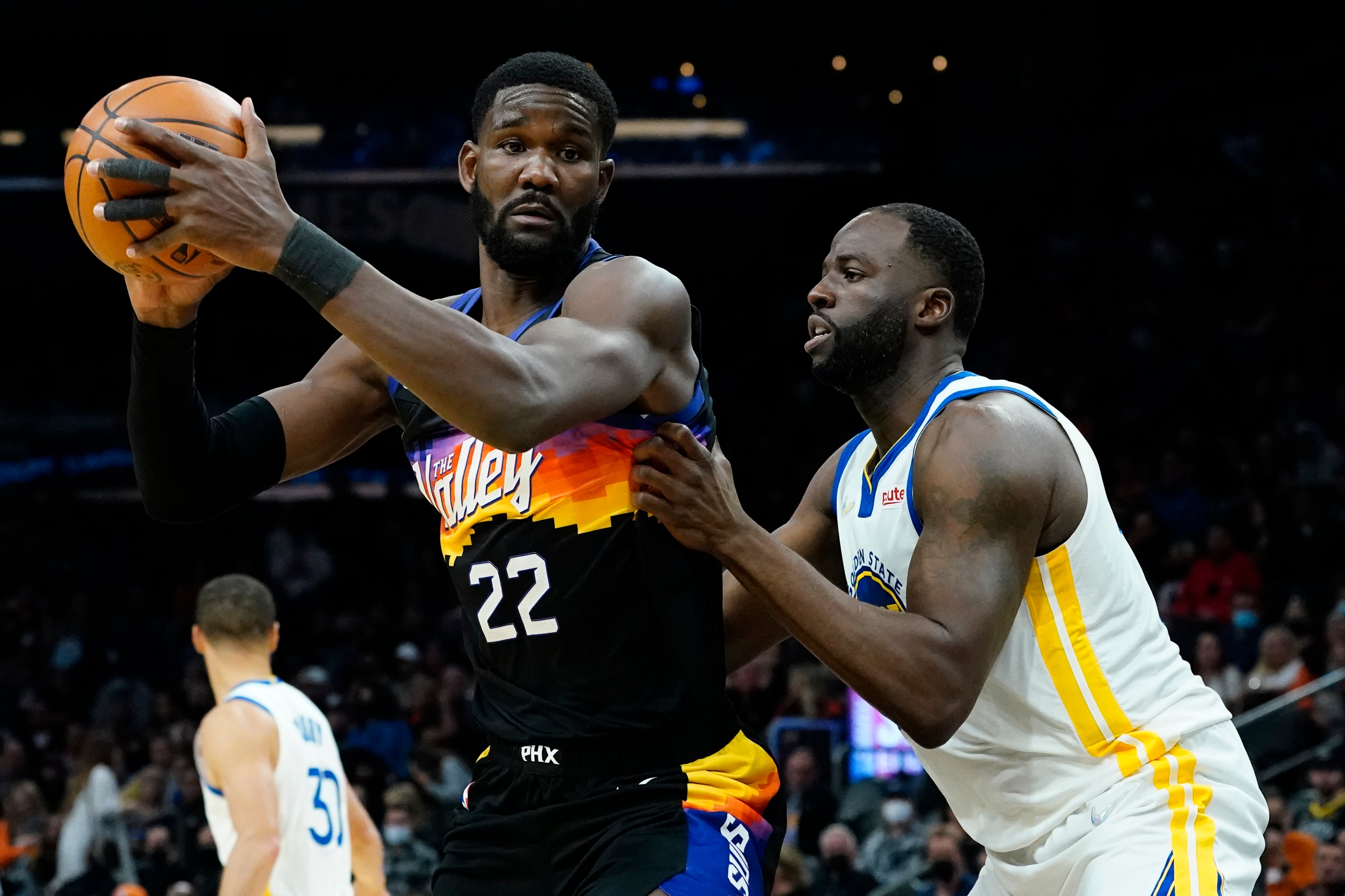 Phoenix Suns centre Deandre Ayton (22) backs down Golden State Warriors forward Draymond Green (Matt York/AP)