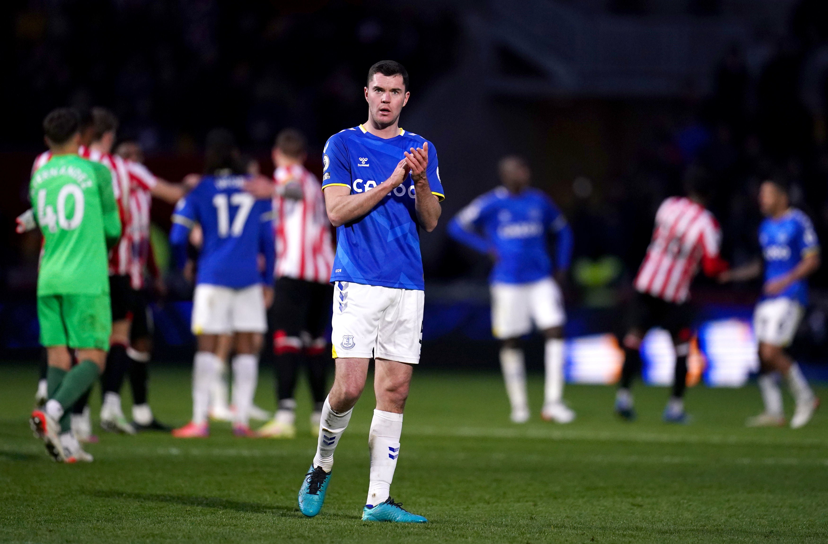 Michael Keane applauds the travelling Everton fans after defeat to Brentford