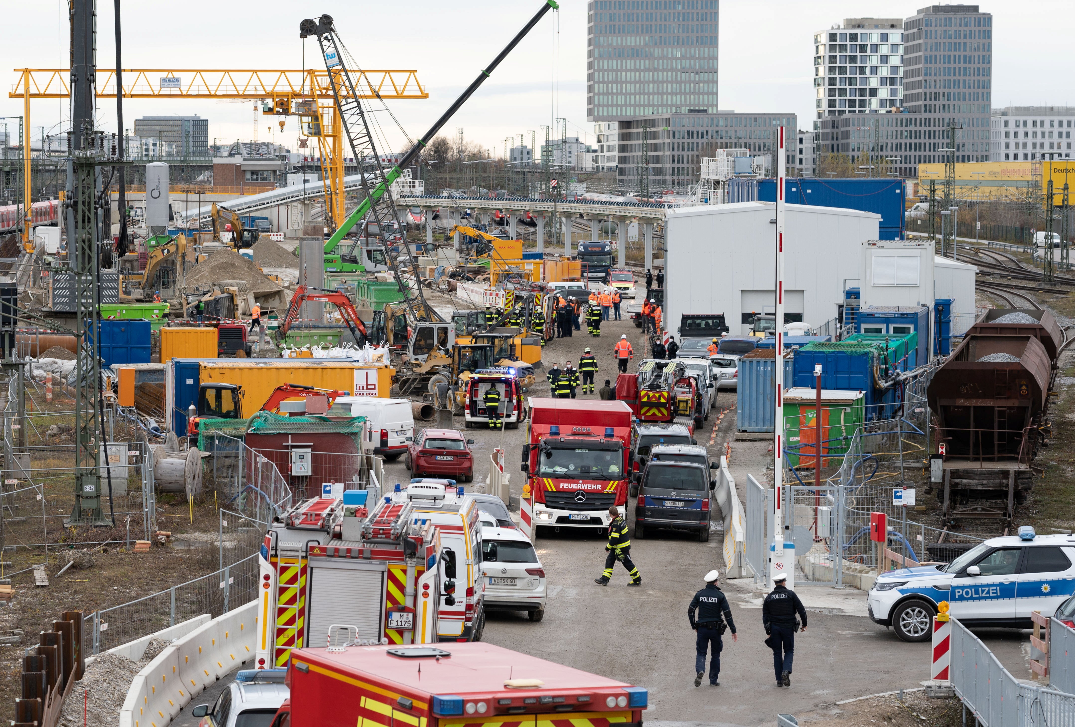 Police and firefighters secure the scene at a bridge by the busy main train station in Munich