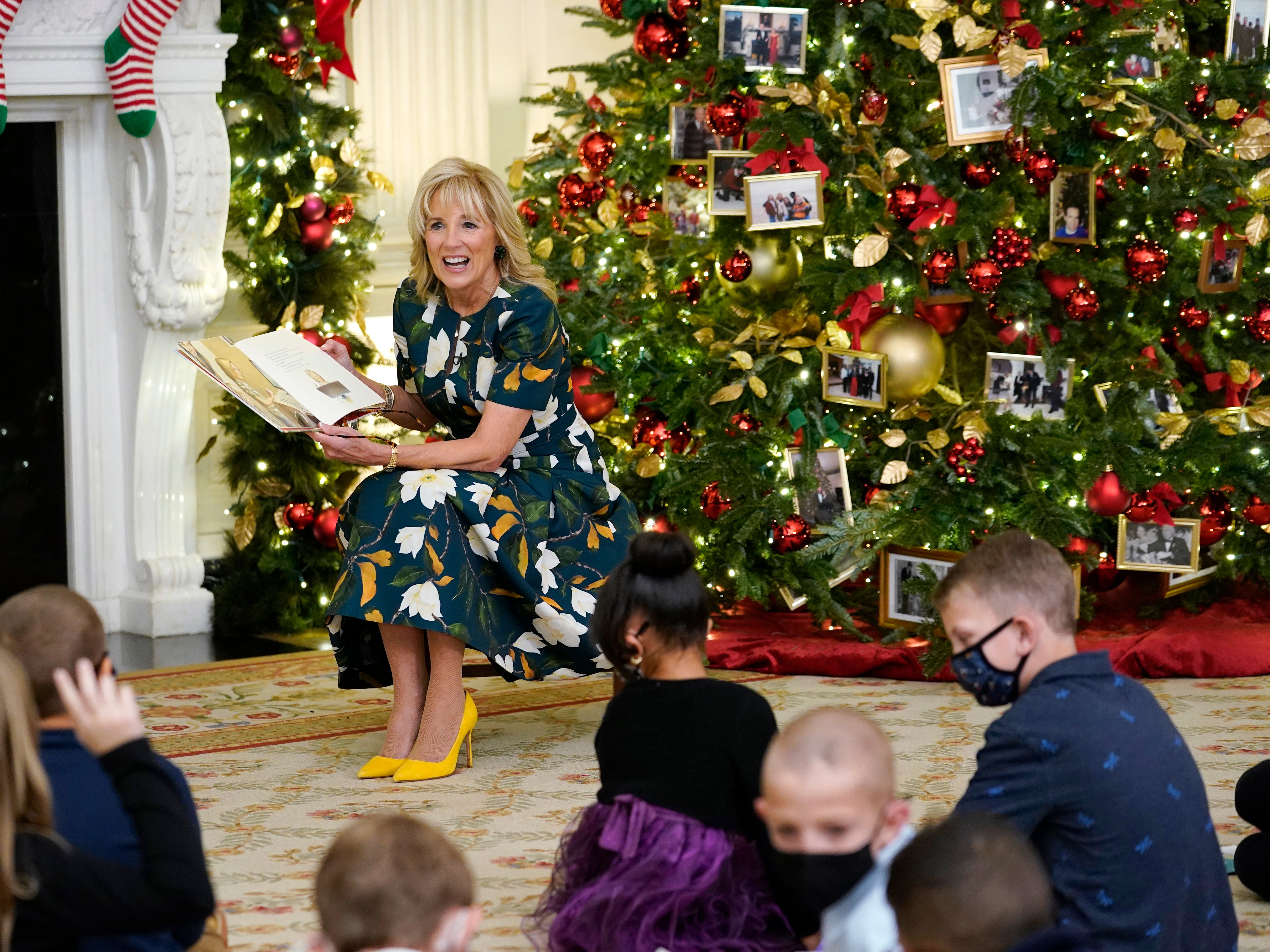 First lady Jill Biden reads a book co-written with granddaughter Natalie, “Don’t Forget, God Bless Our Troops,” to a group of students from Malcolm Elementary School