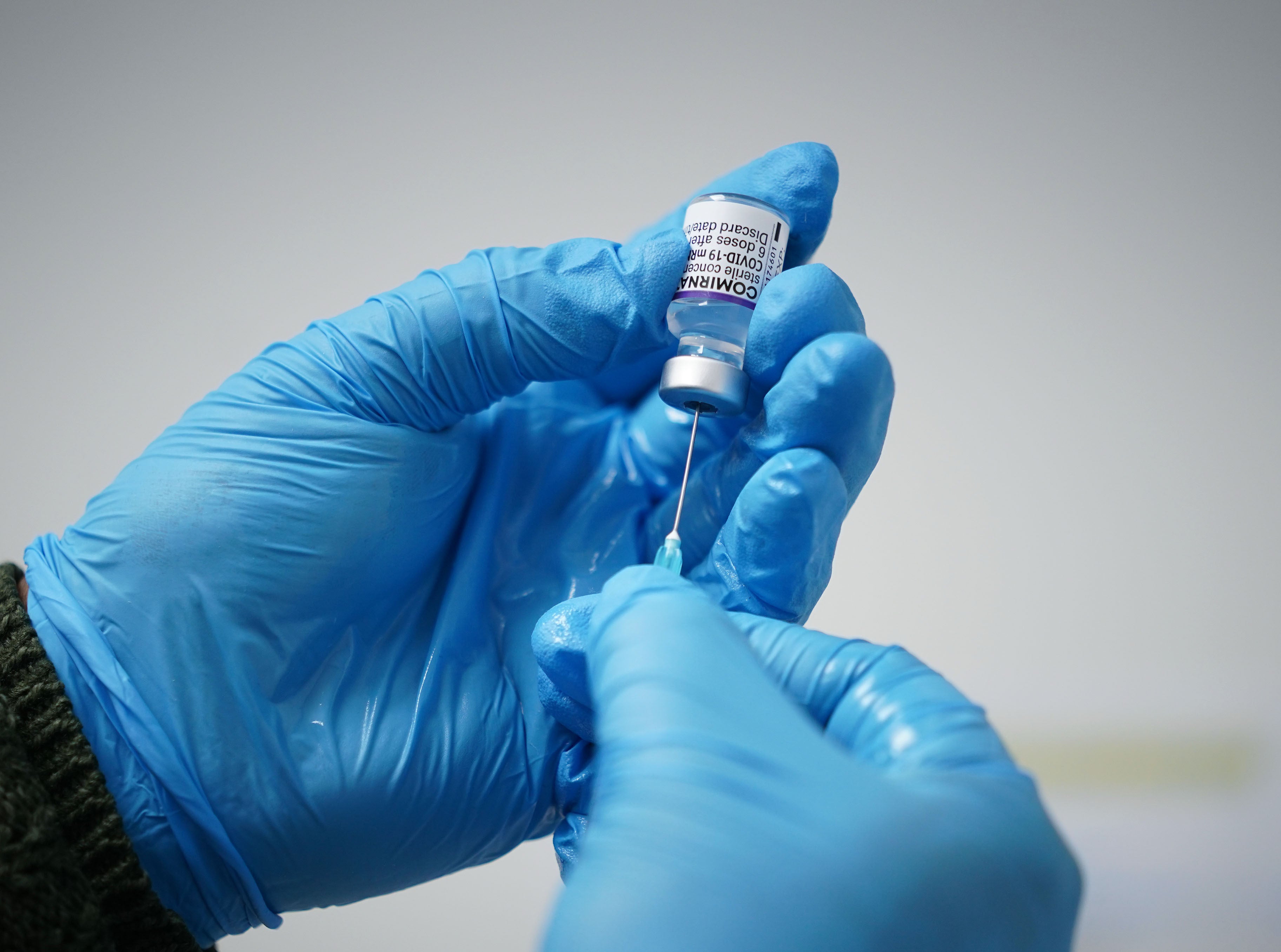 A dose of the Pfizer booster jab is prepared (PA)