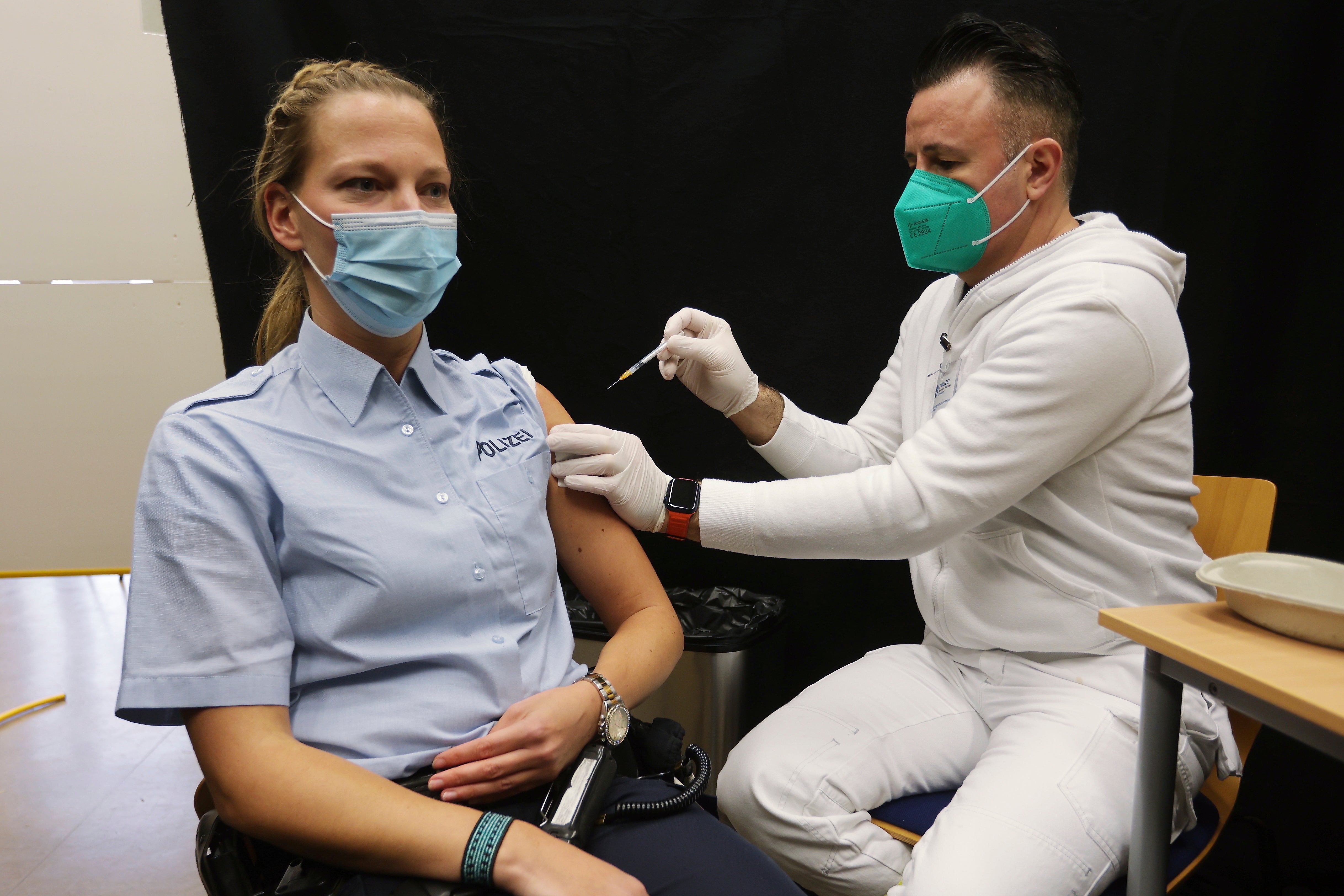 A police officer receives her vaccine in Hilden, Germany