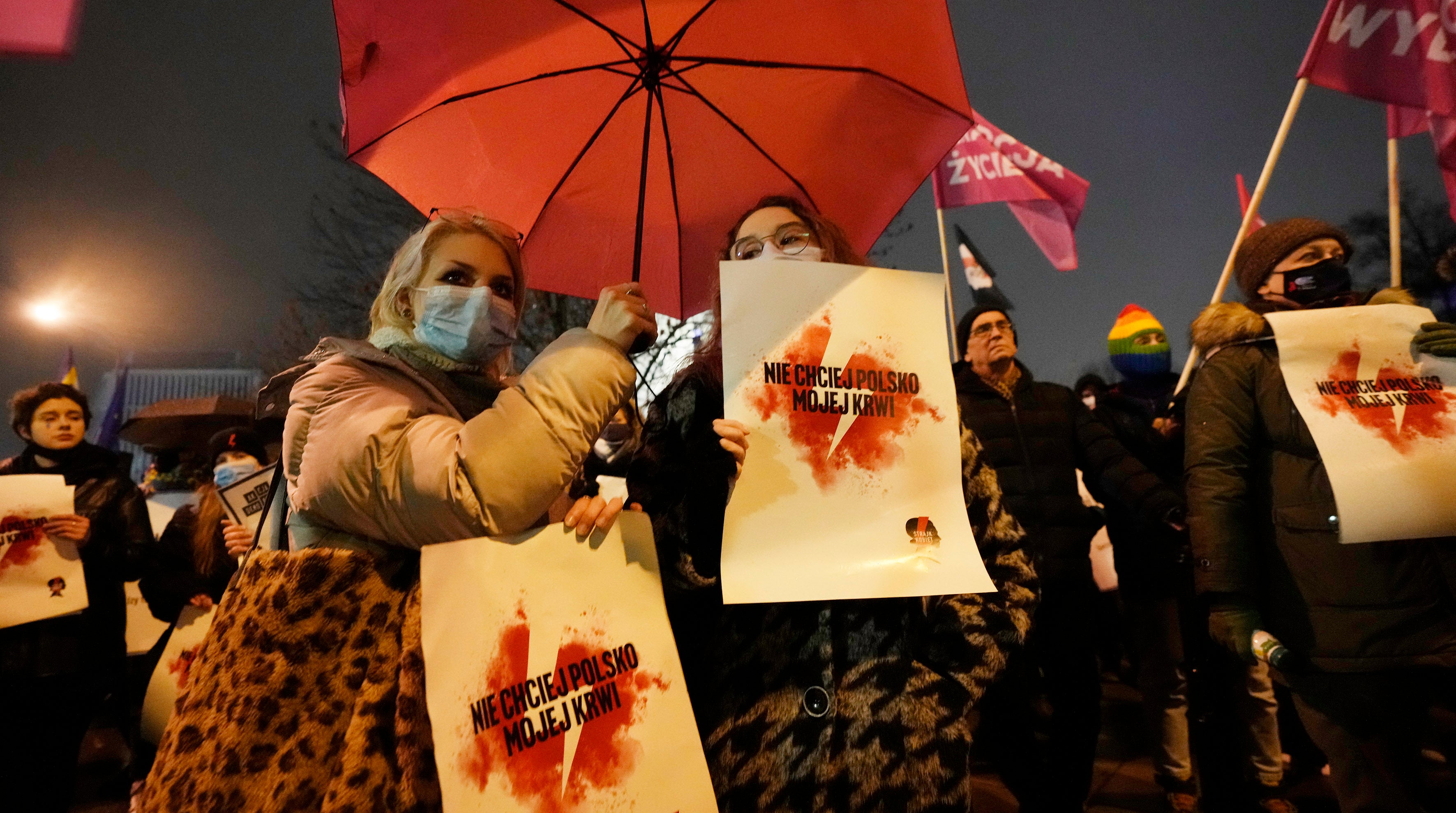 Women hold signs saying “Don’t ask for my blood, Poland” in Warsaw