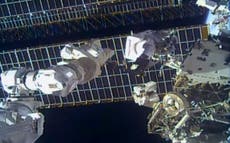 Spacewalking astronauts replace antenna after debris scare