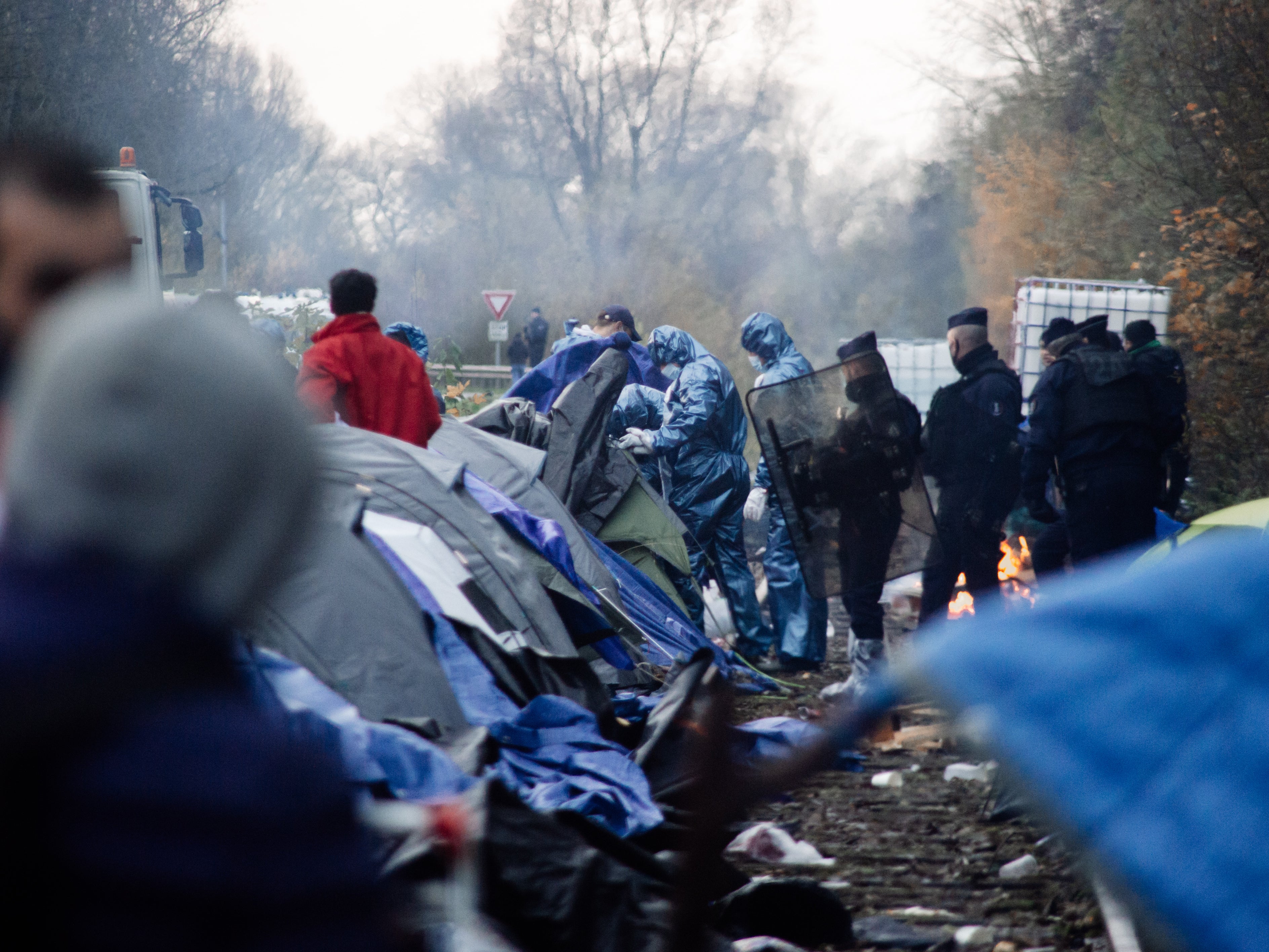 Police and workers in protective gear dismantle the Grande-Synthe camp earlier this week