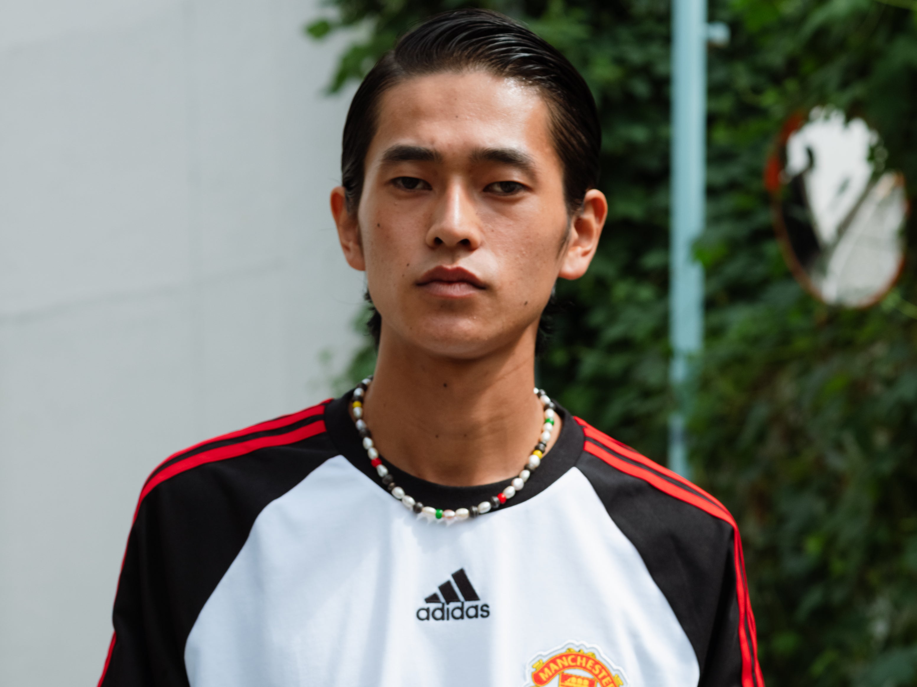 A model poses in the Manchester United jersey from the Teamgeist collection with Adidas