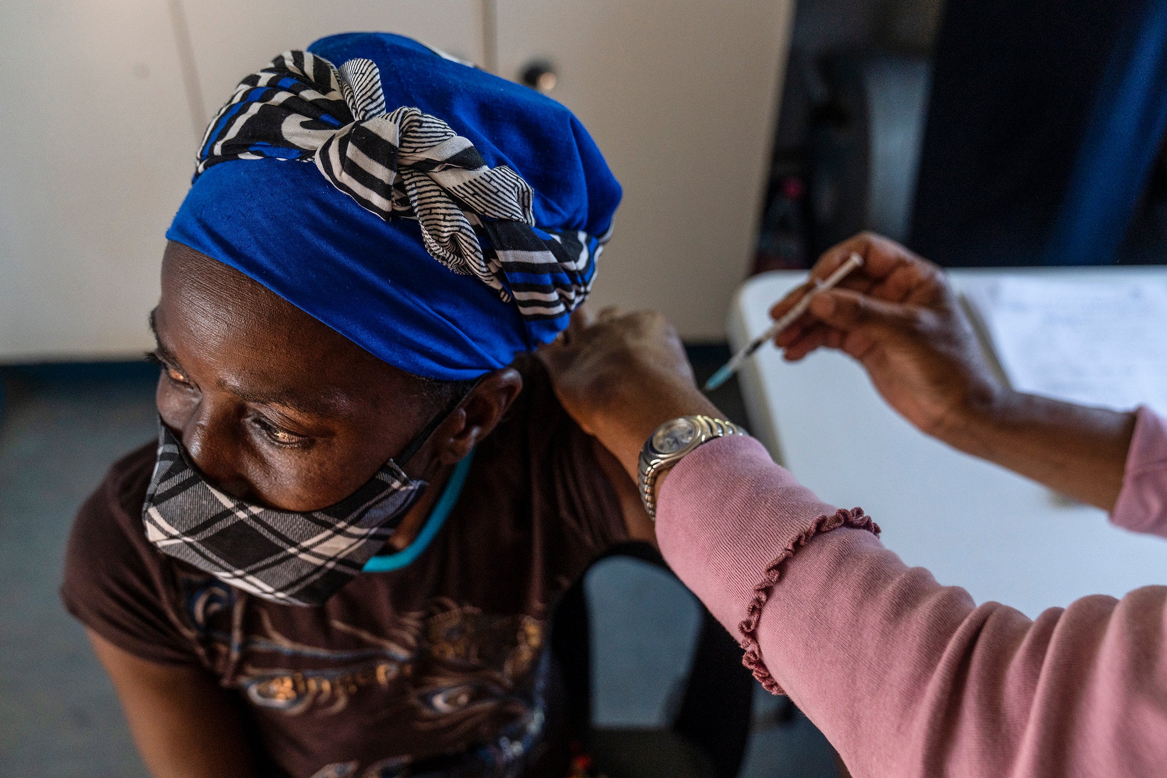 A woman is vaccinated against Covid-19 at the Lenasia South Hospital, near Johannesburg, on Wednesday