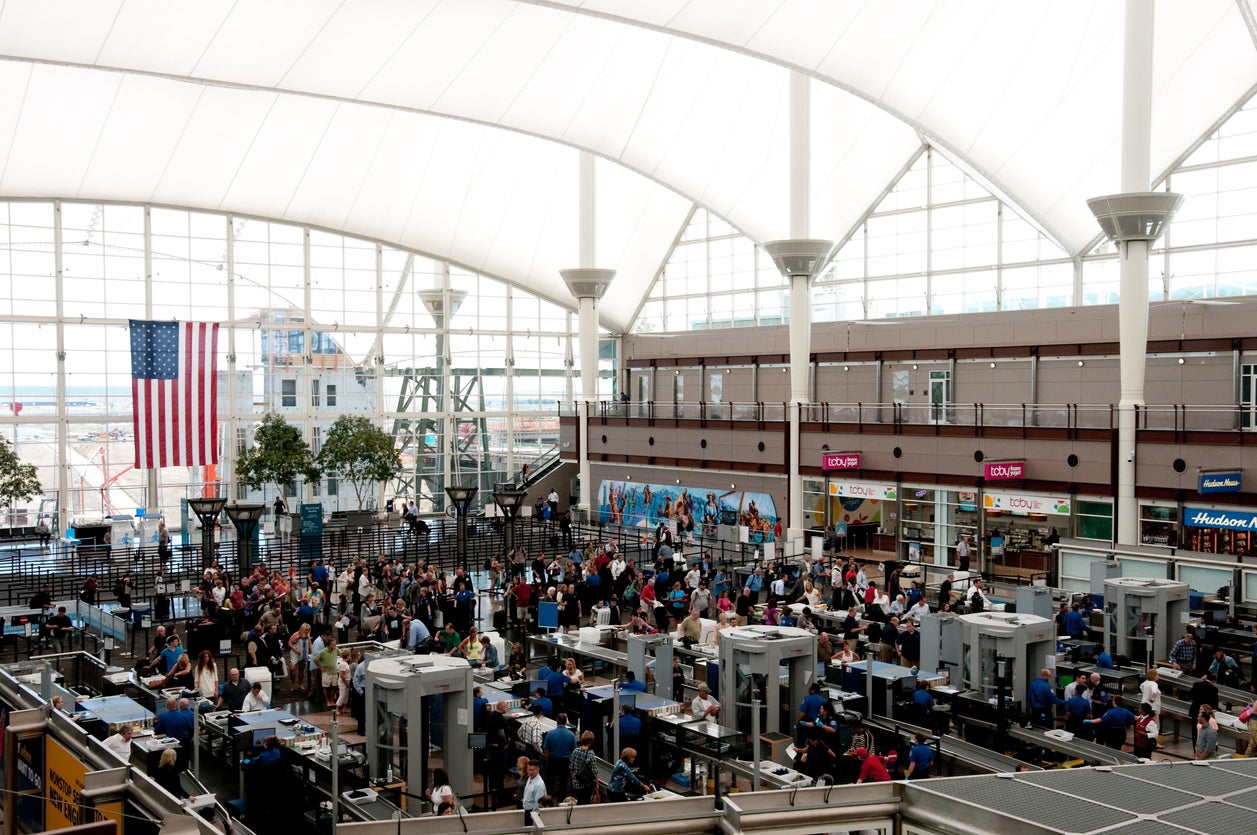 Tourists moving through security at Denver International Airport