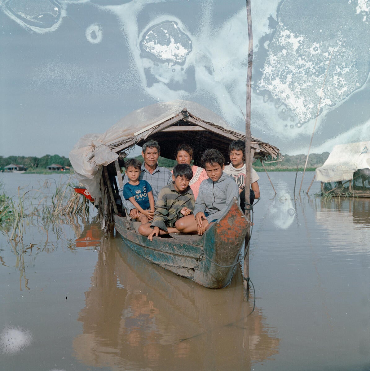 Chenla (far right) on the houseboat with parents Sambath and Youn, and siblings Ratin, aged 5, Din, 11, and Oudung, who is 12