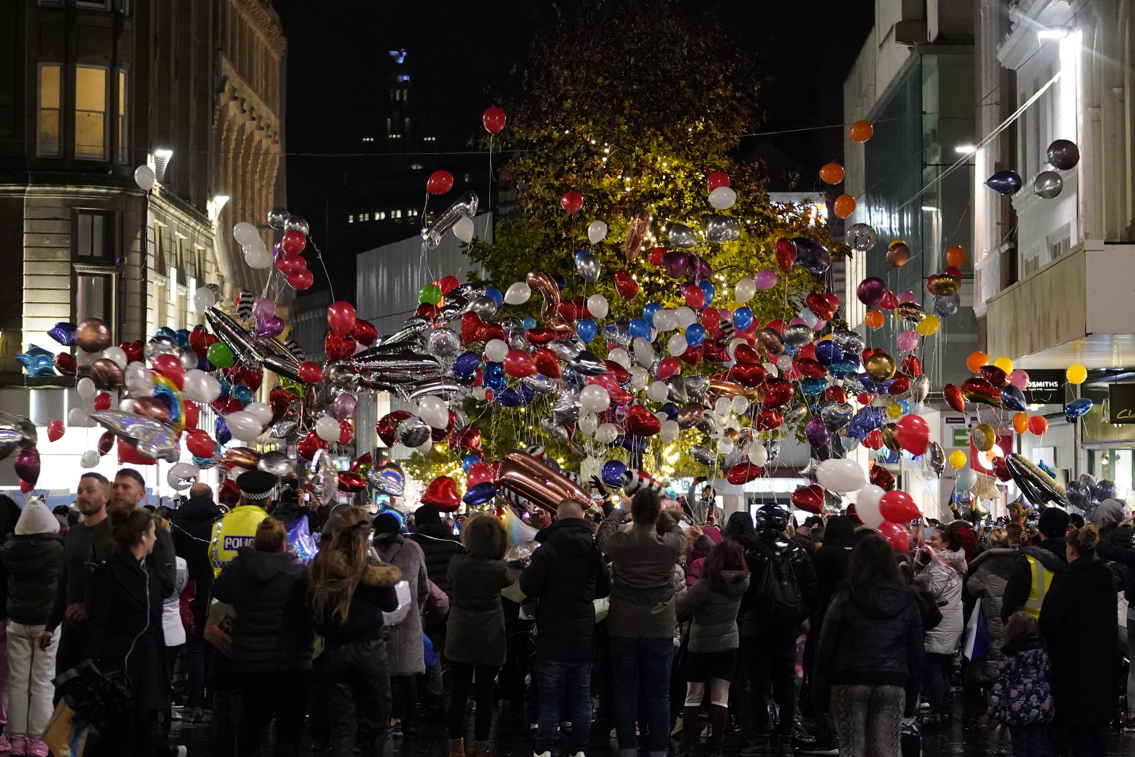 Balloons are released as people take part in a vigil in Liverpool city centre for 12-year-old Ava White (Danny LAwson/PA)