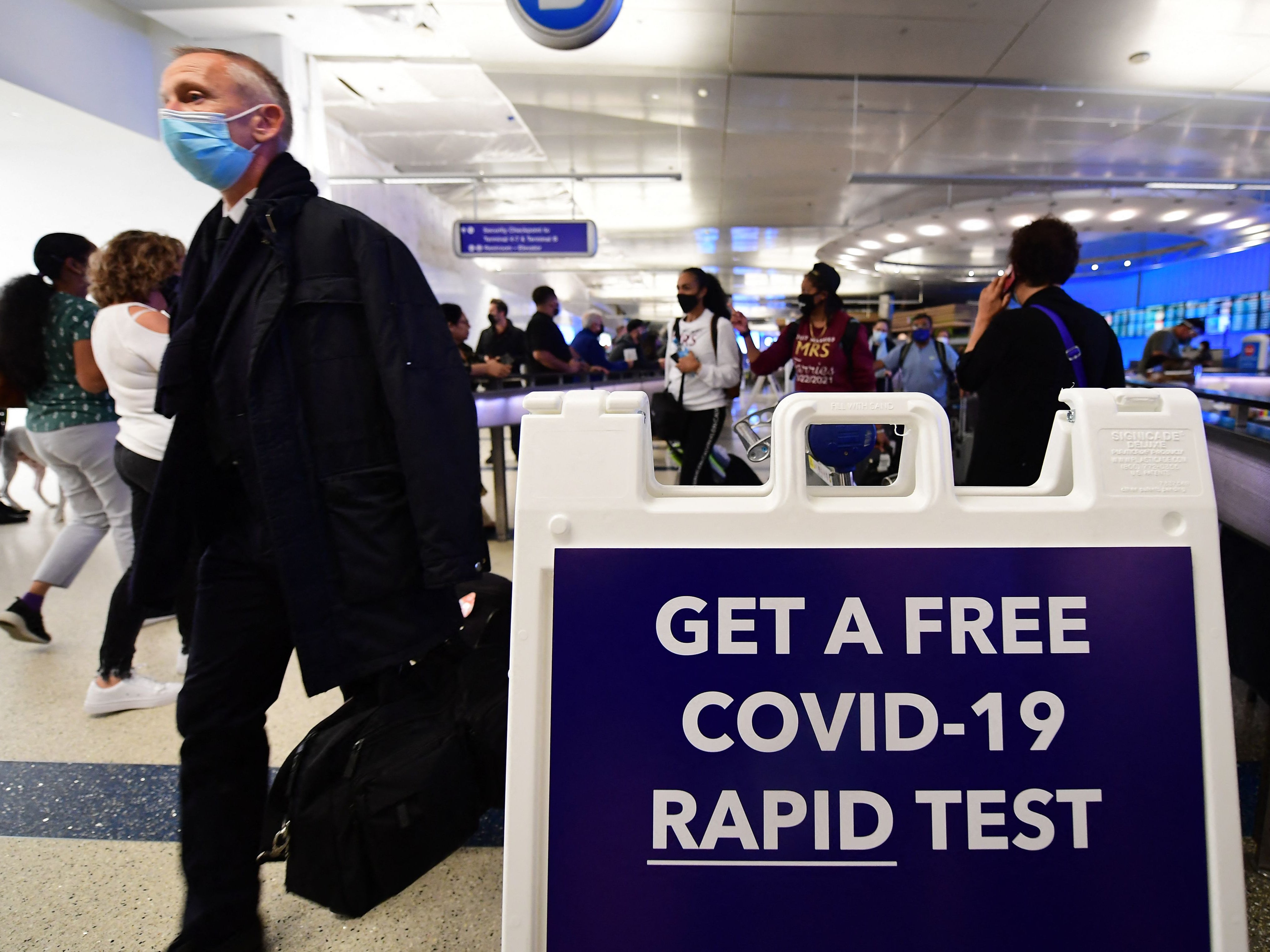 Travellers from abroad arrive at Los Angeles International Airport on 3 December, 2021