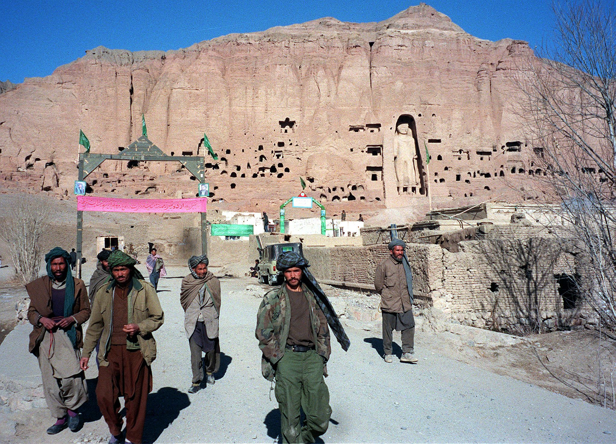 Soldiers belonging to a Shia faction on patrol in front of the ancient Buddha statue in Bamiyan province