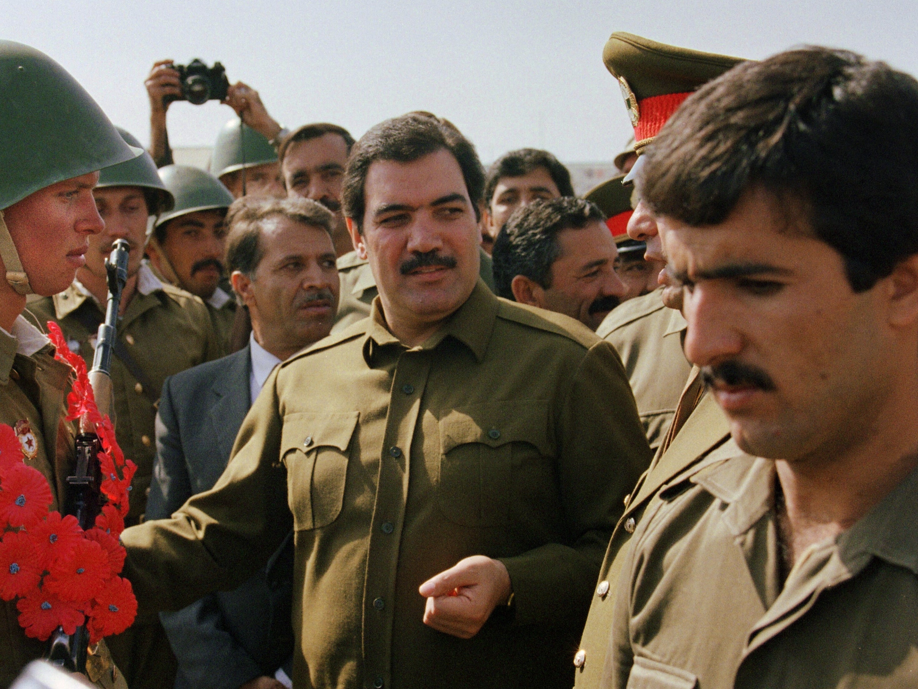 Afghanistan’s former president, Mohammed Najibullah, smiles as he meets Red Army soldiers in October 1986