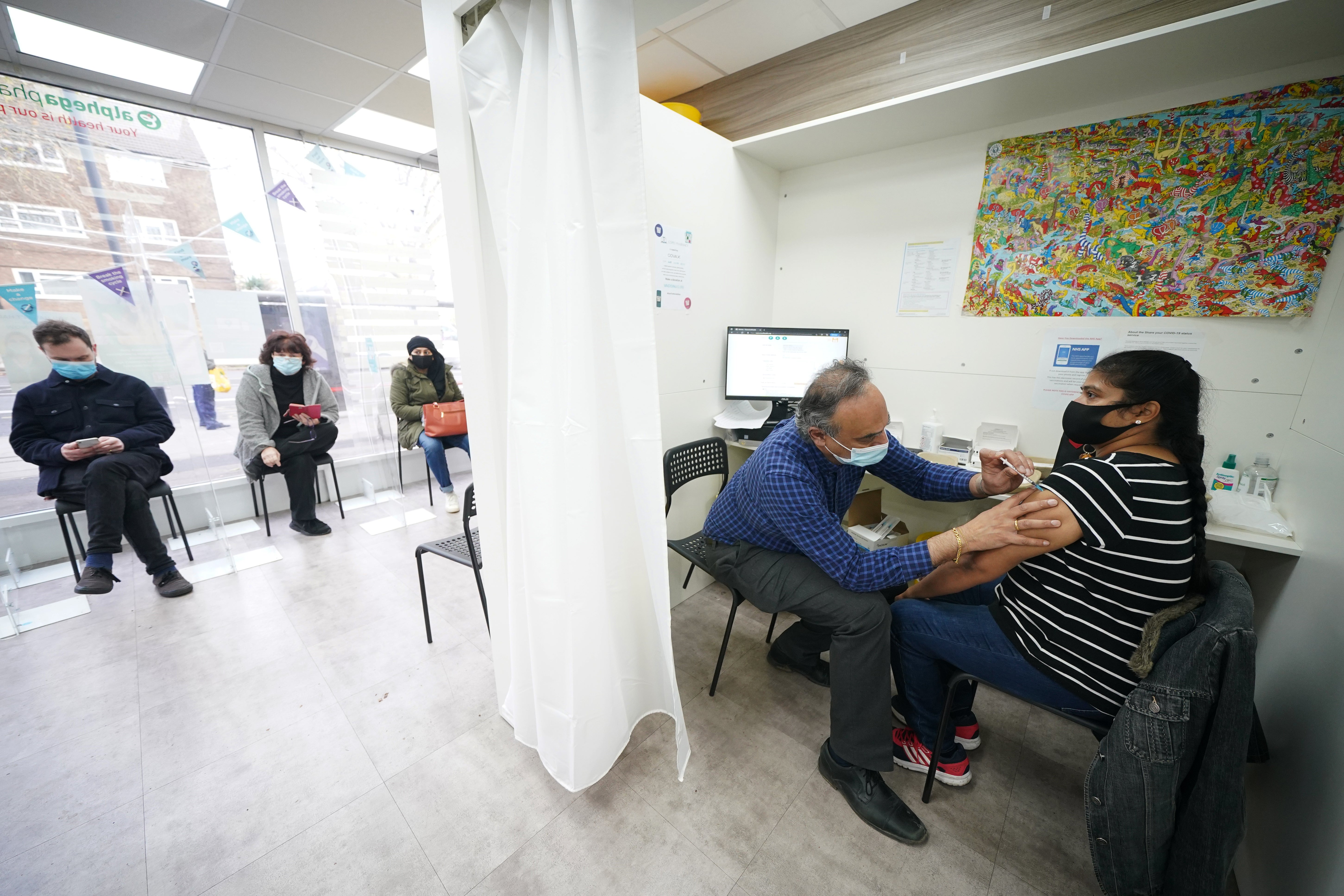 Niranjala Prabakar receives her Covid-19 booster vaccine jab at Copes Pharmacy in Streatham, south London (Yui Mok/PA)