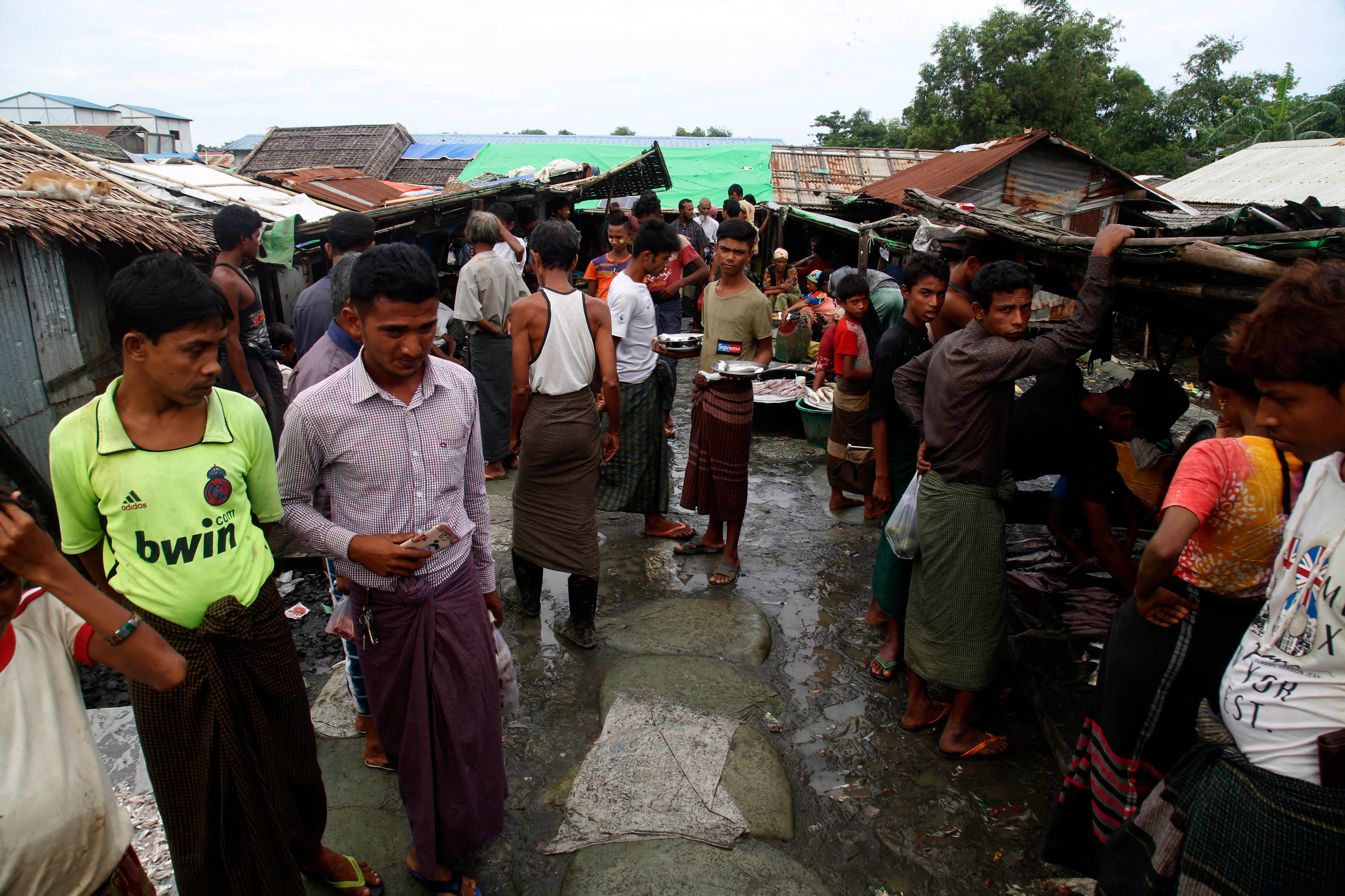 Internally displaced Rohingya walk at a market area in the Baw Du Pha IDP Camp in Sittwe in Myanmar’s western Rakhine state