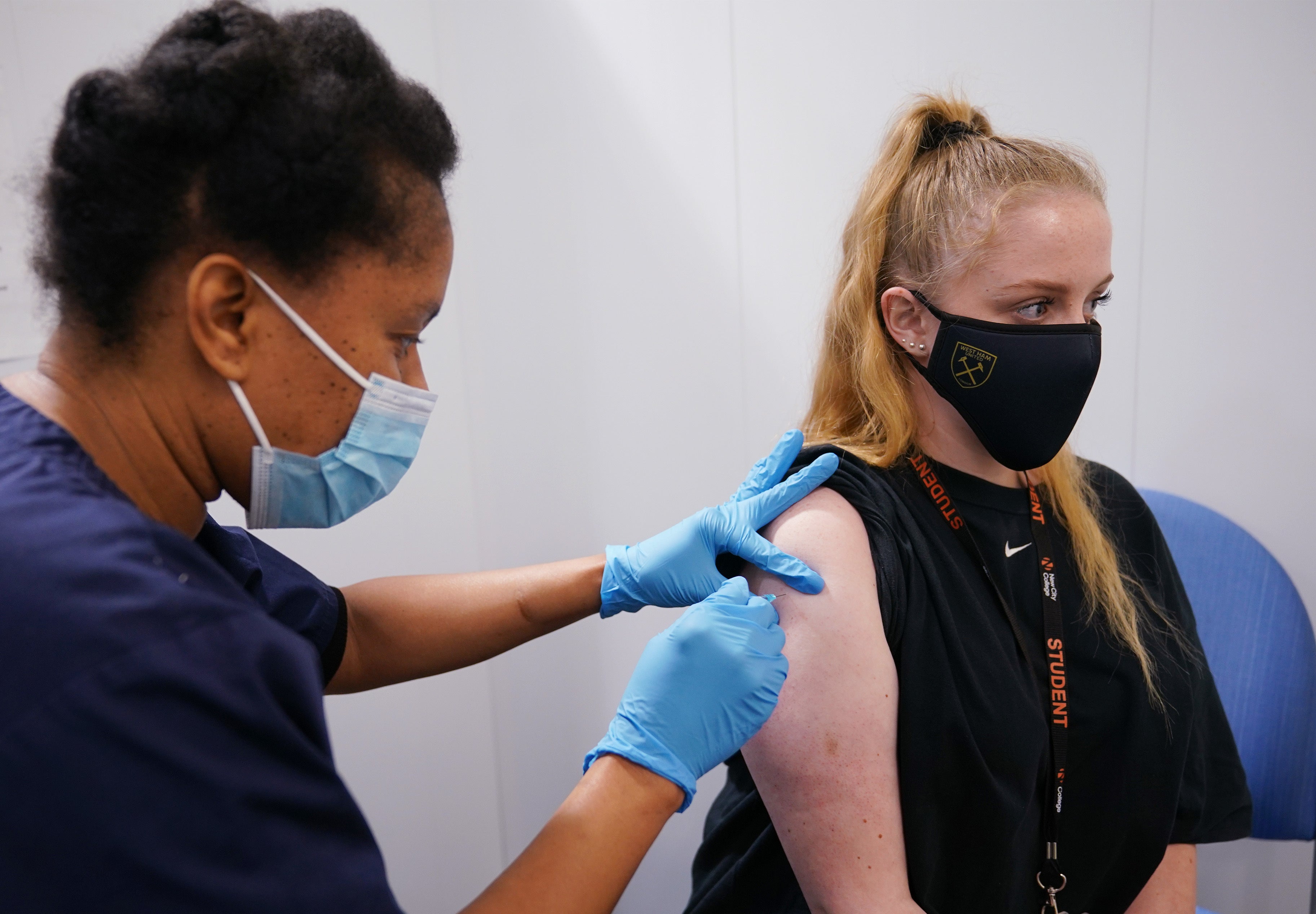 A woman receives her second dose of the Pfizer Covid-19 vaccination (PA)