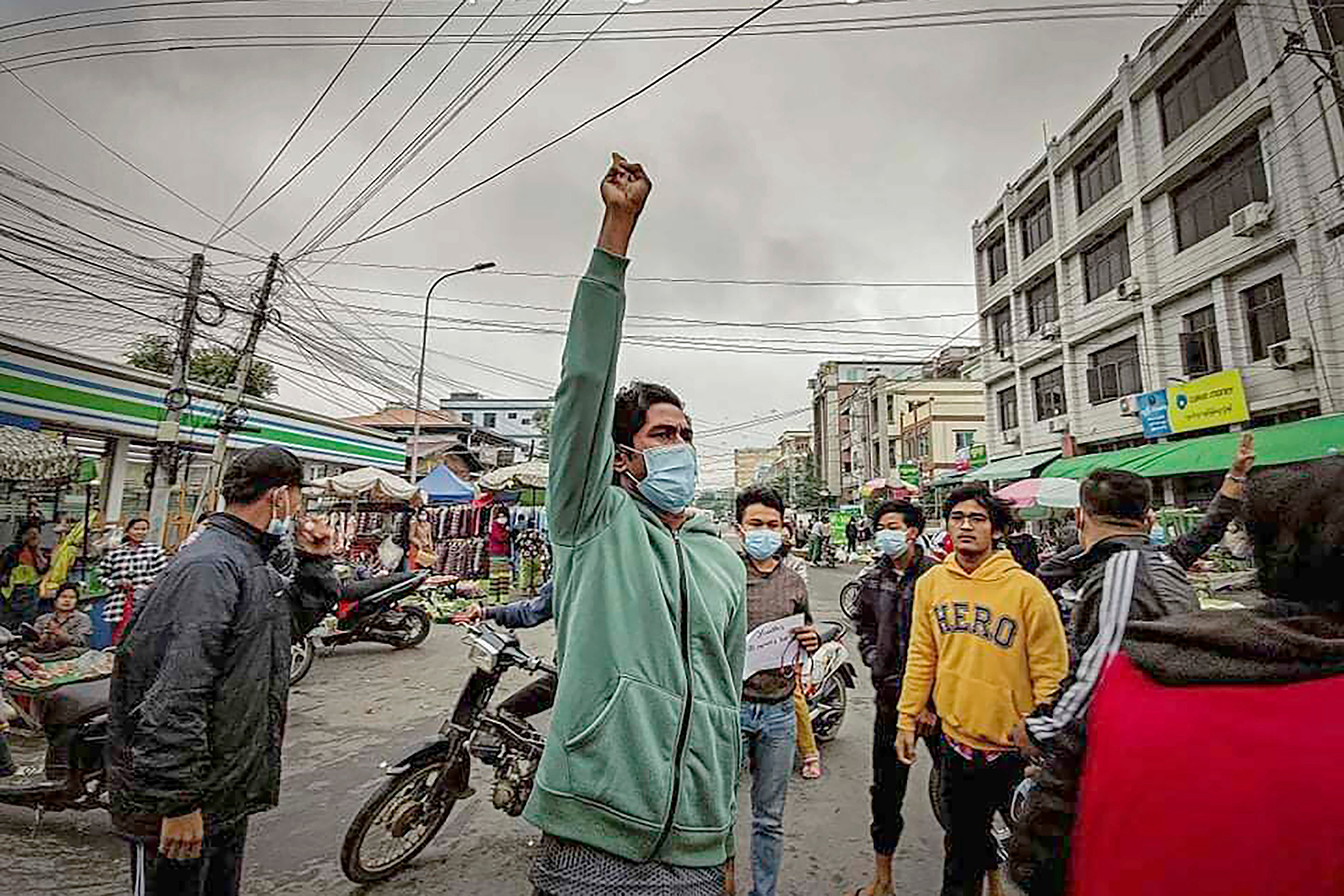 Protesters march through the streets during an anti-government demonstration in Mandalay on Tuesday