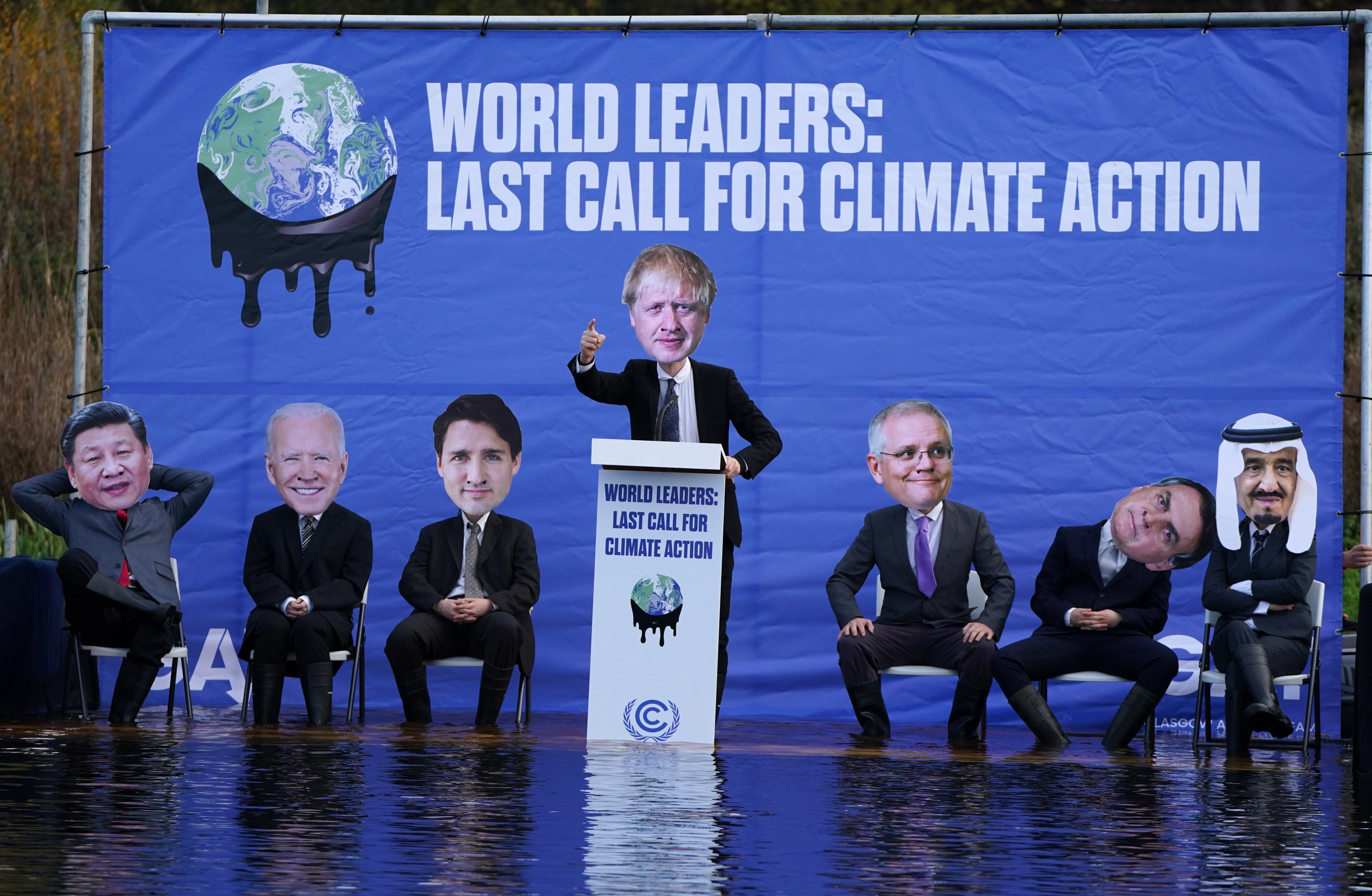 A replica of the Cop26 summit’s main UN negotiation stage, carrying activists dressed as world leaders (Andrew Milligan/PA)